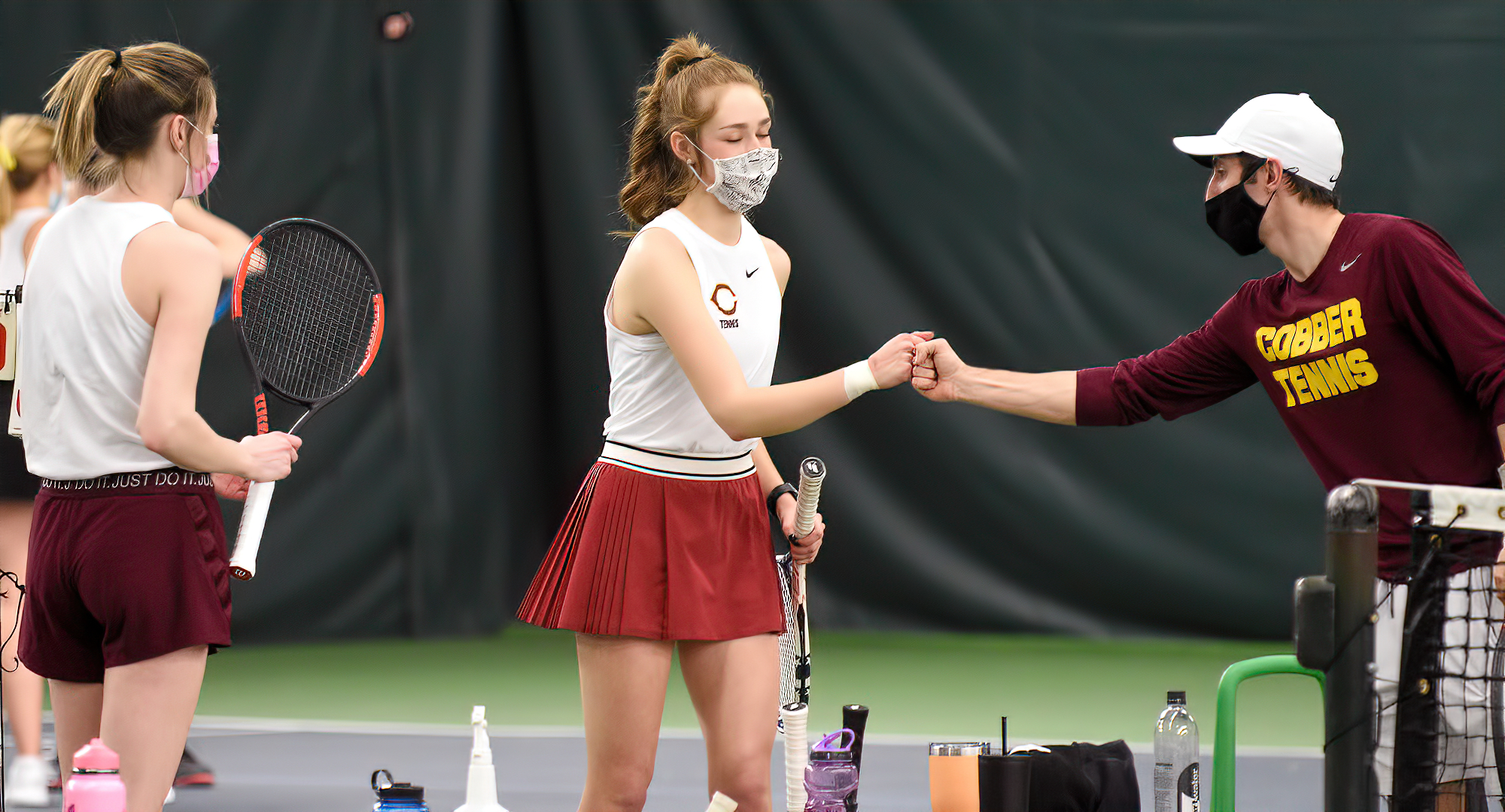 Raquel Egge (center) was one of two players to capture singles victories for the Cobbers in their match at St. Mary's. She won 6-3, 6-1 at No.1 singles.