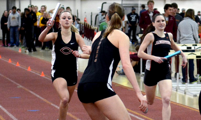 Anna Skow-Anderson gets ready to grab the baton from teammate Kylee Fernholz in the 4x400-meter relay at the Cobber Duals.