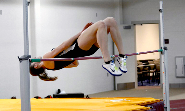 Junior Anna Skow-Anderson arches over the bar in the high jump of the MIAC pentathlon. She finished second in the event.