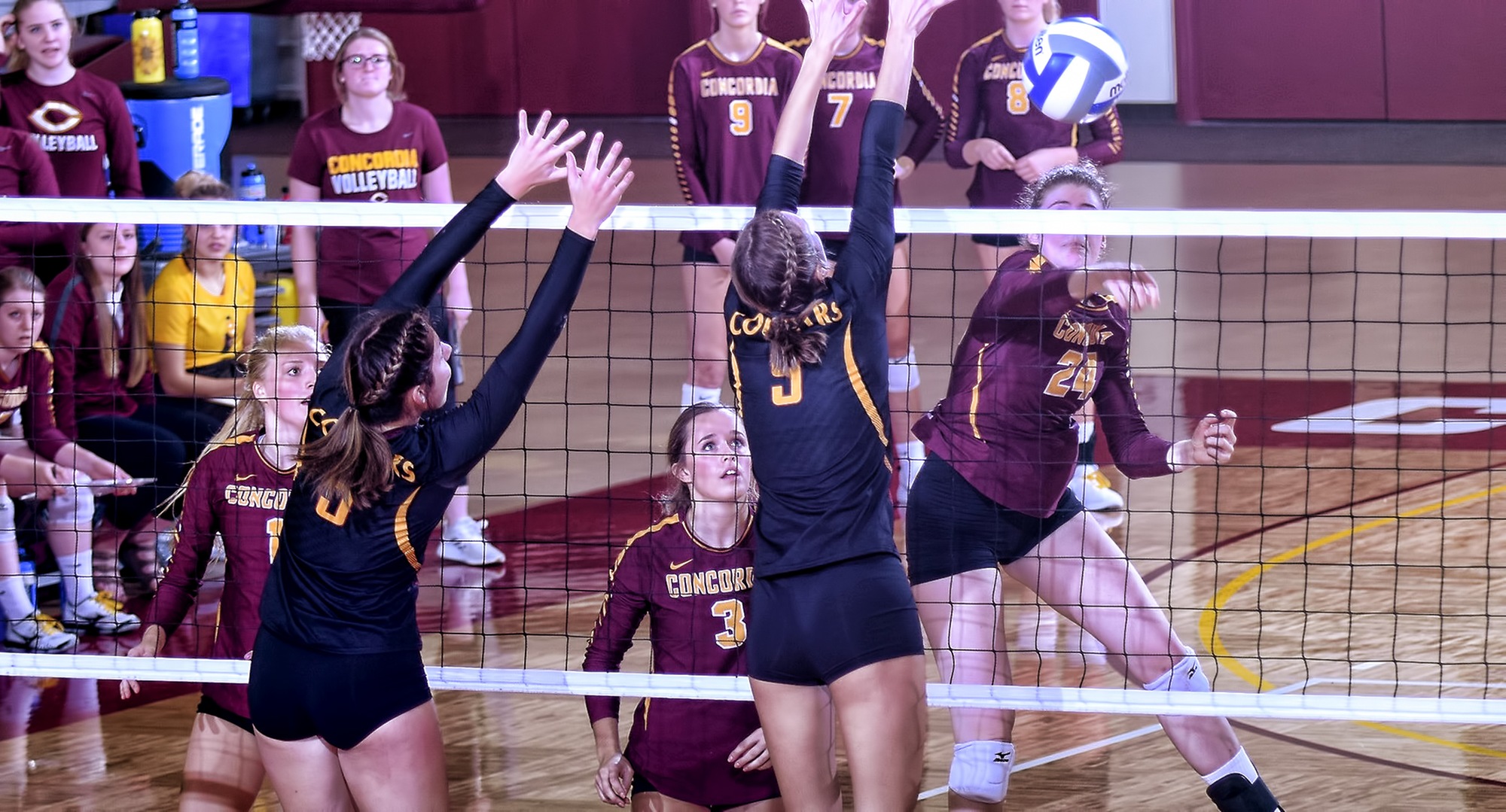 Sophomore Kendra Wiggs pushes the ball past the block in the third set of the Cobbers' non-conference match with Minn.-Morris.