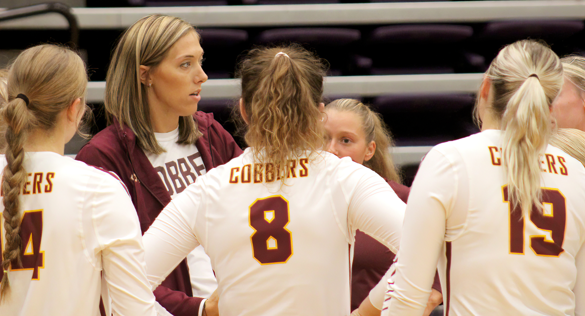 Head Coach Faith Radermacher discusses strategy during a timeout on Day 1 of the Mary Hardin Baylor Tourney (Photo courtesy of: Caleb Marek)