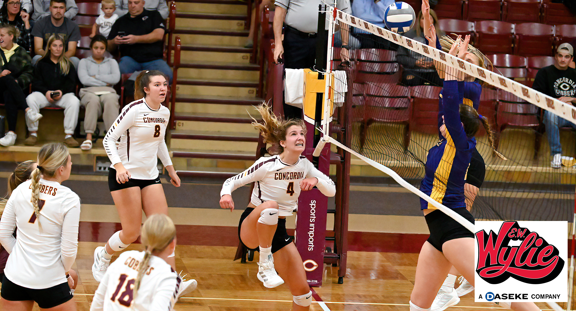 Maria Watt (#4) watches the ball roll over the net for one of her six kills in the Cobbers match against St. Catherine.