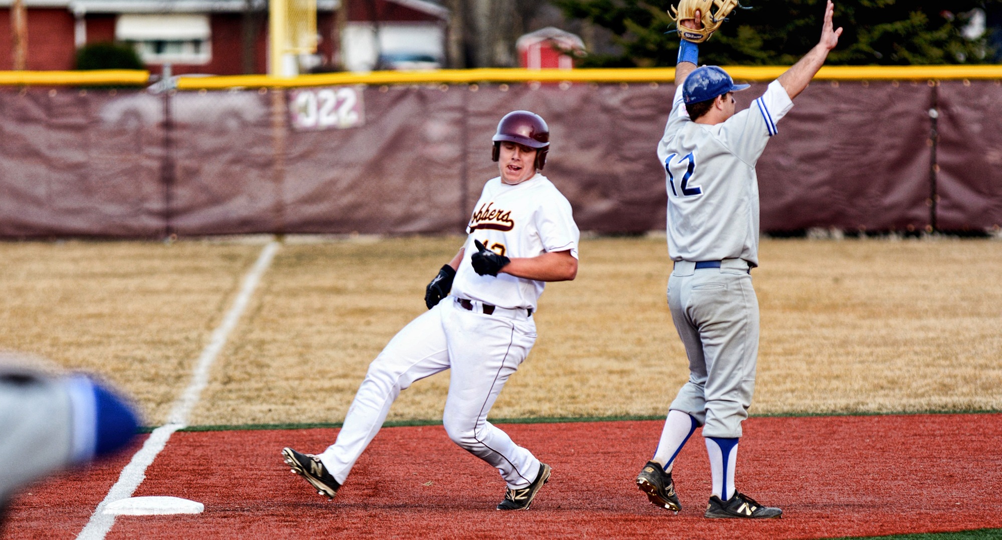 Junior Nate Leintz glides into third base in the 10th inning of the Cobbers' home opener against Mayville State.