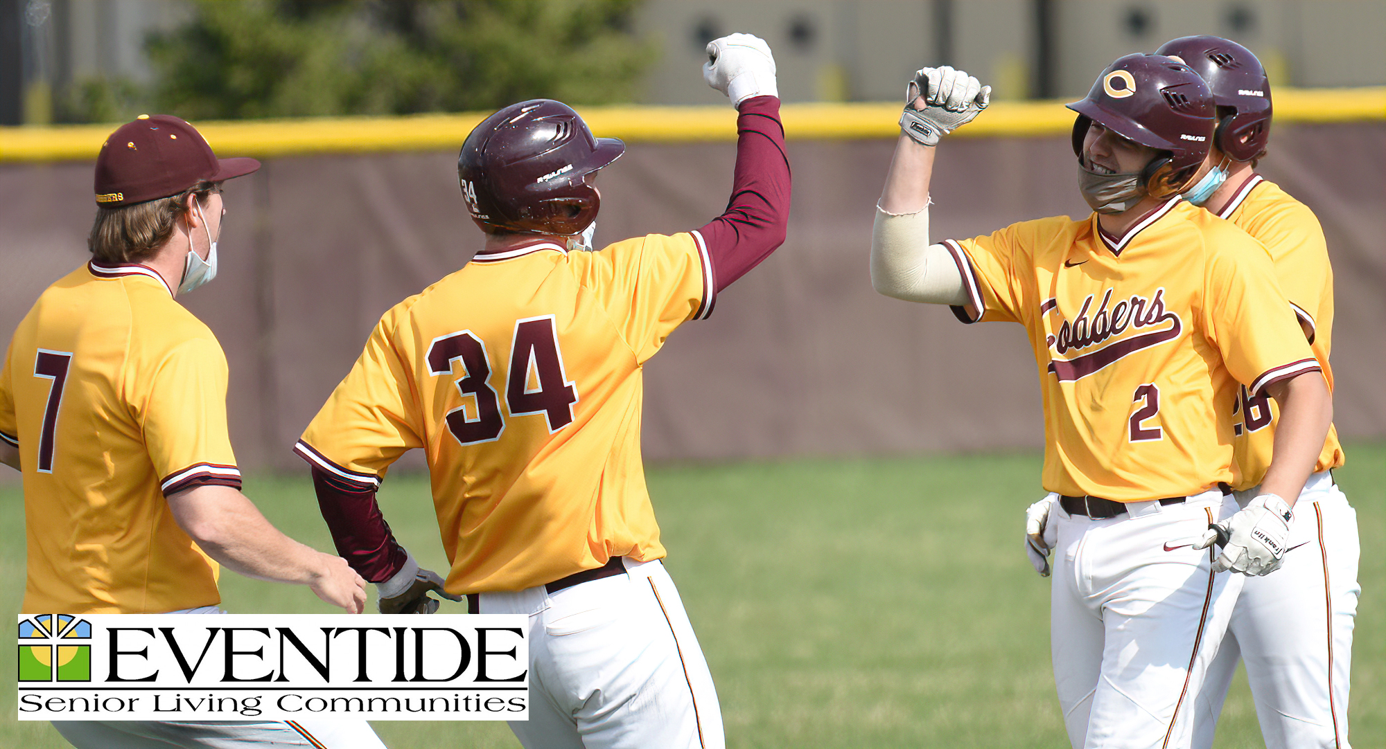 Players rush to congratulate Matt Gruber (#2) after Gruber hit the first of two Cobber walkoff hits in their sweep over Carleton.
