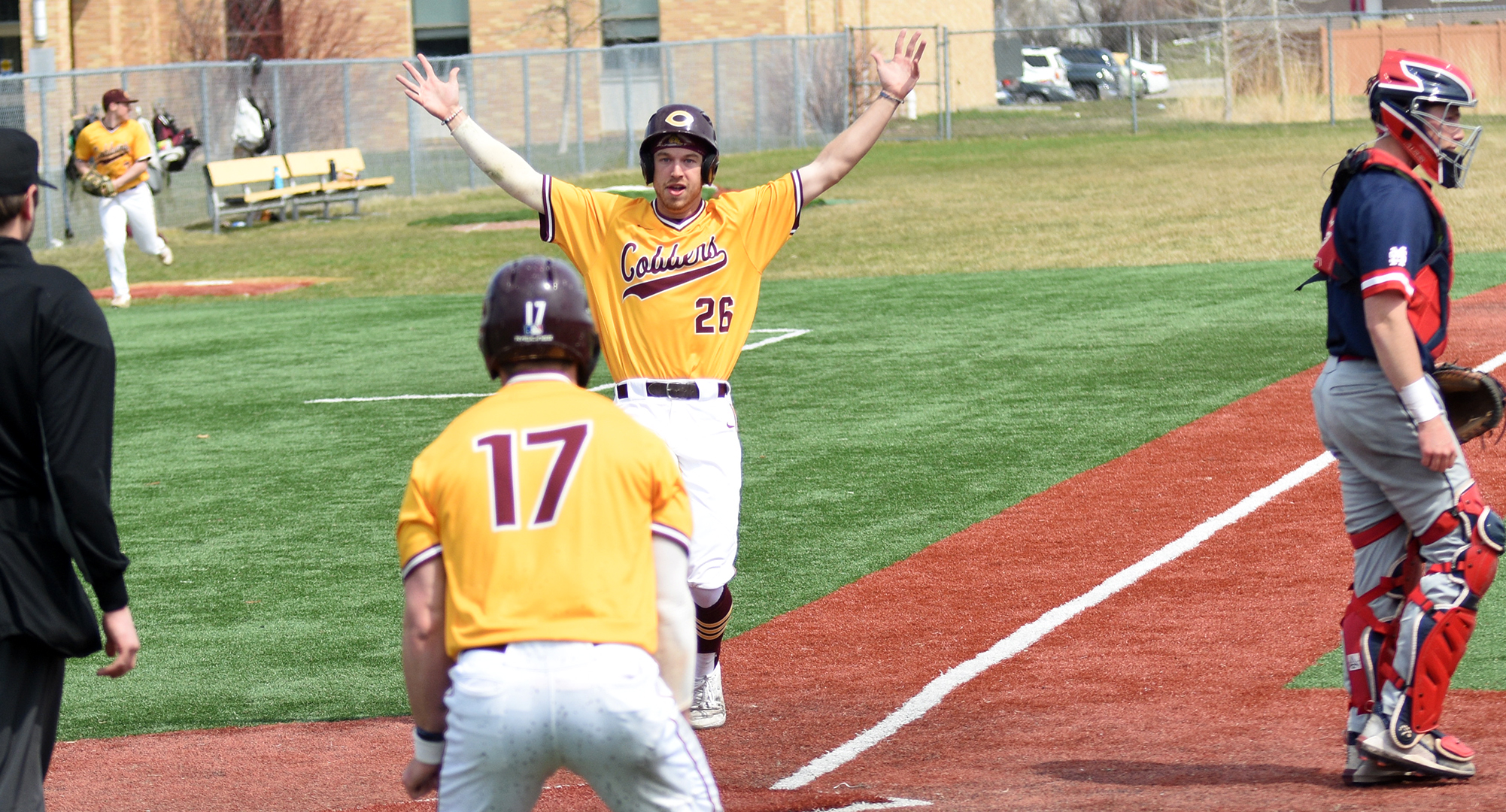 Noah Pilon raises his arms to celebrate scoring the game-winning run in the Cobbers 3-2 victory over St. Mary's in the opener of the DH.