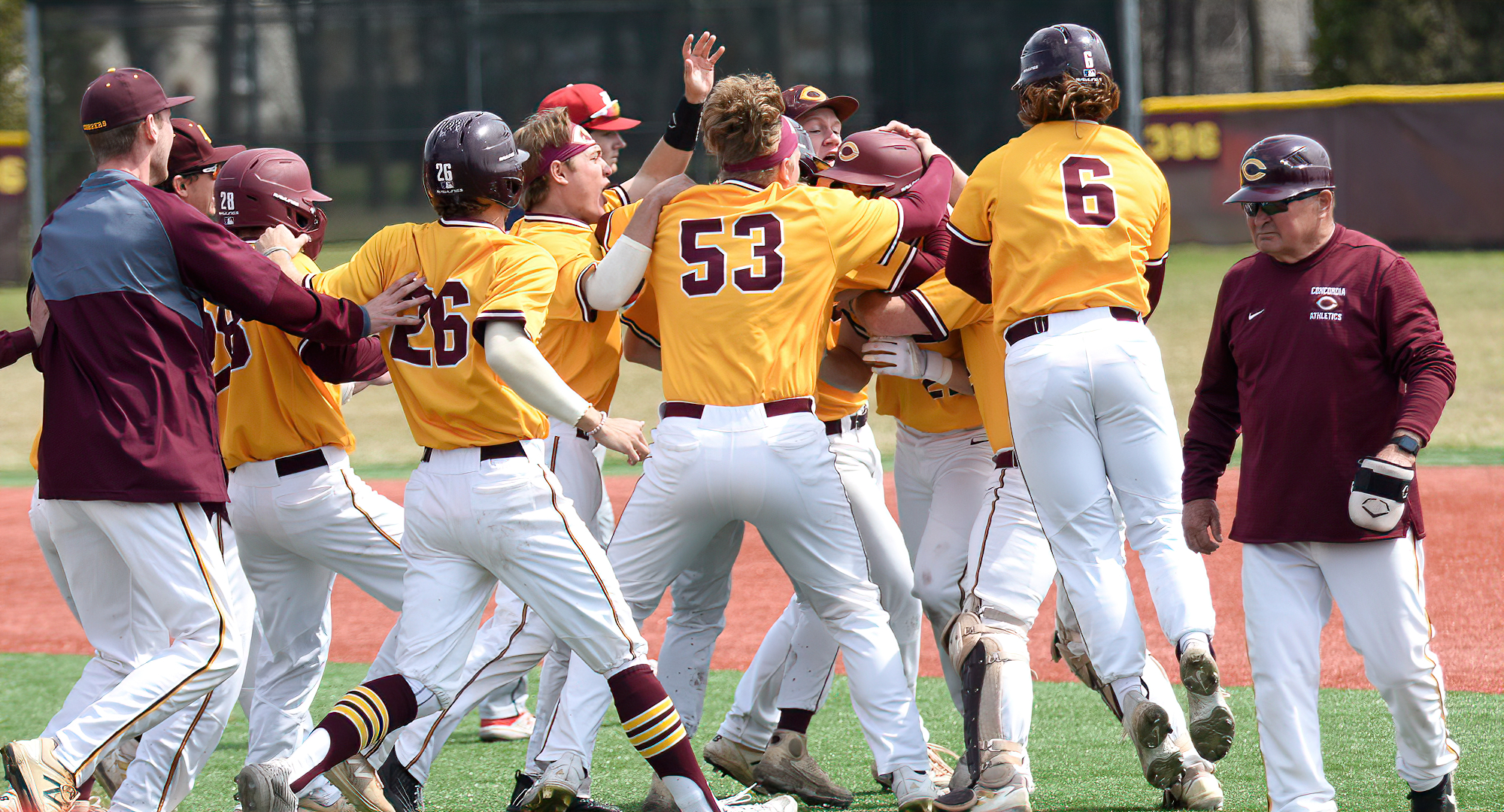 Cobber players celebrate the come-from-behind, extra-inning win in their Game 1 win over St. Mary's.
