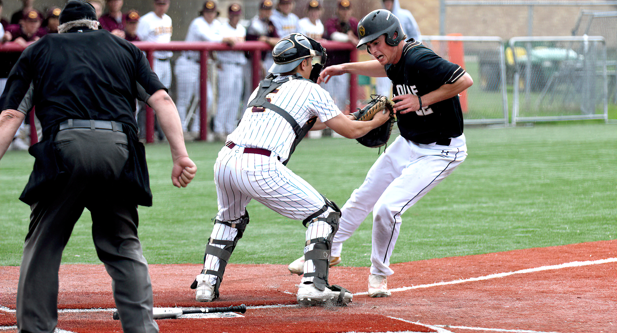 Catcher Carter Mulcahy tags out a St. Olaf base runner at the plate during the second game of the Cobbers' split with the Oles.