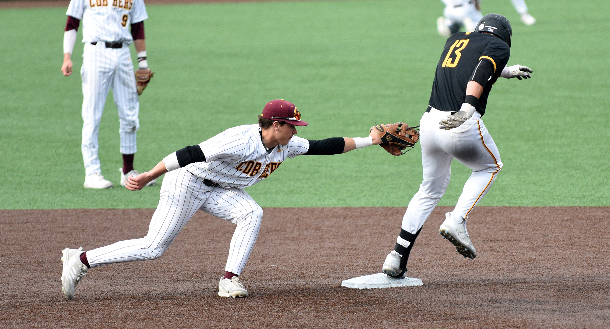 Jake Christianson lunges to put the tag on a Gustavus baserunner during the elimination game on Day 2 at the MIAC tournament.