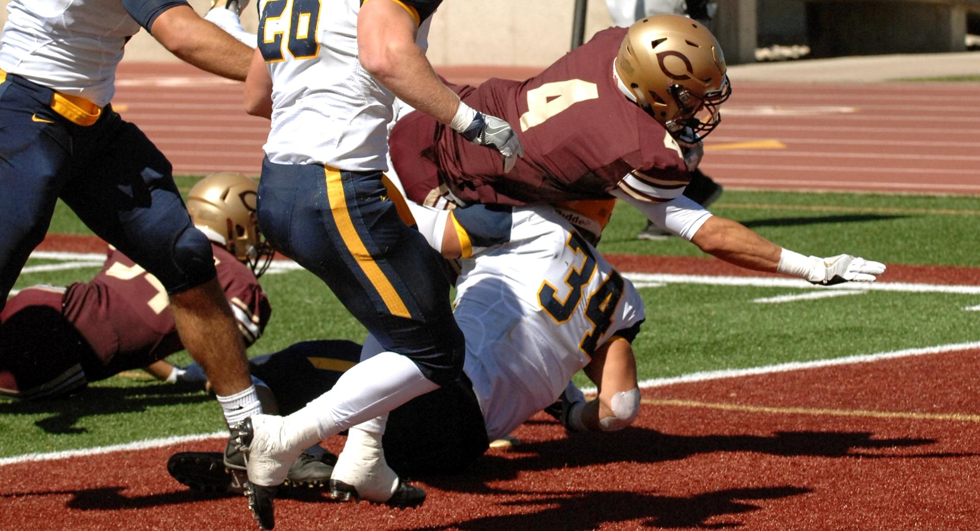 Junior running back Jason Montoyne runs over a Blugold defender on his way to a first-quarter touchdown in the Cobbers 25-7 win.