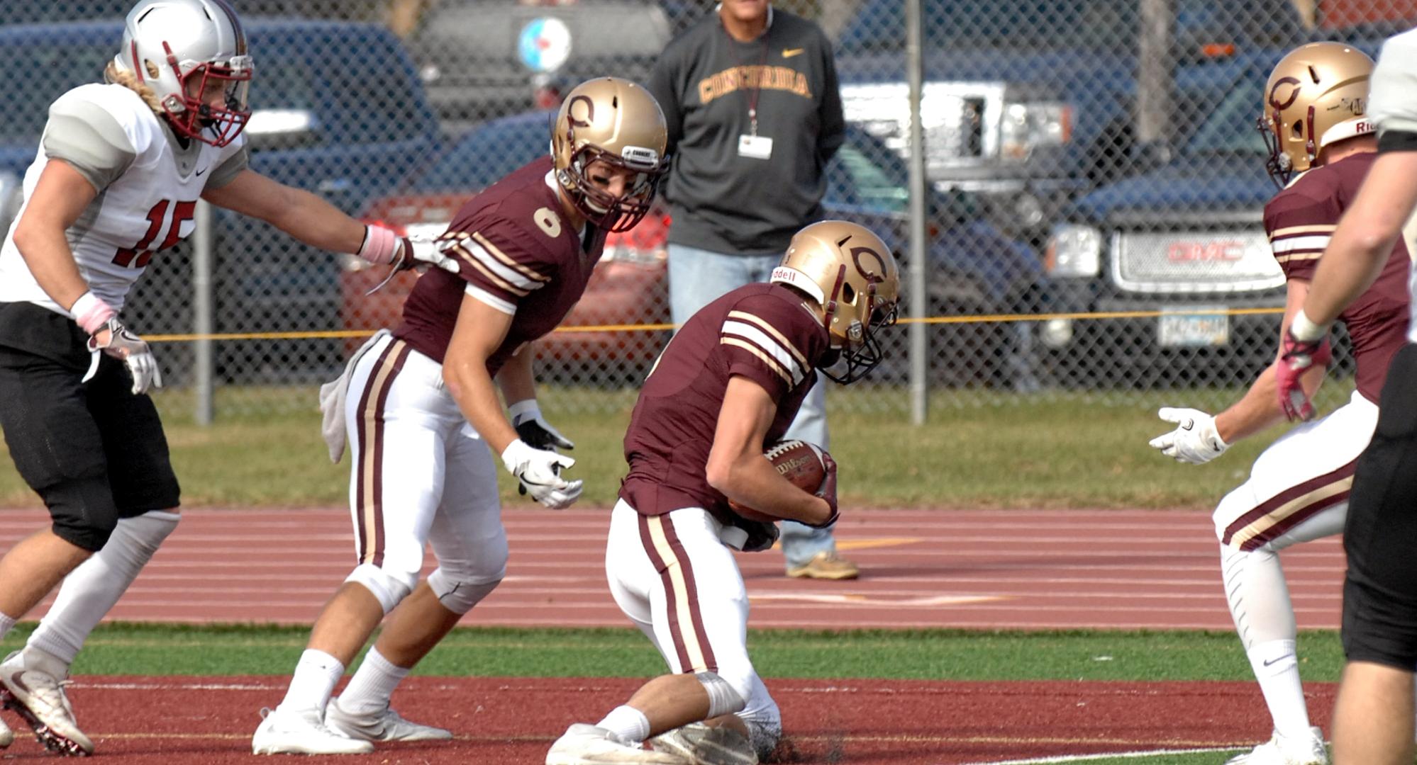 Senior Dylan Hoerchler comes down with a "hail mary" pass at the end of the first half in the Cobbers' 34-14 win over Hamline.