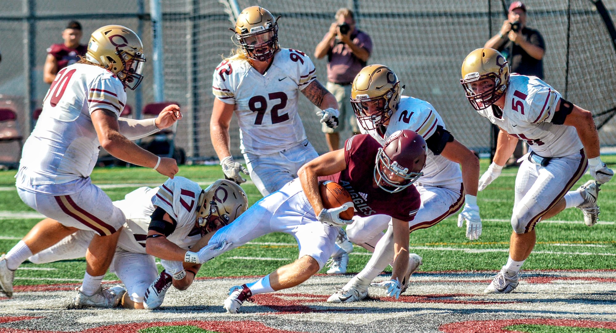 The Cobber defense swarms the Augsburg ball carrier during Concordia's 54-7 win. (Photo courtesy of BJ Pickard - MIAC Office)