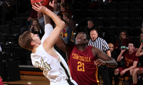 Senior forward Ebo Nana-Kweson blocks a shot during the Cobbers' 85-70 win at St. Olaf. (Photo courtesy of St. Olaf sports information office)