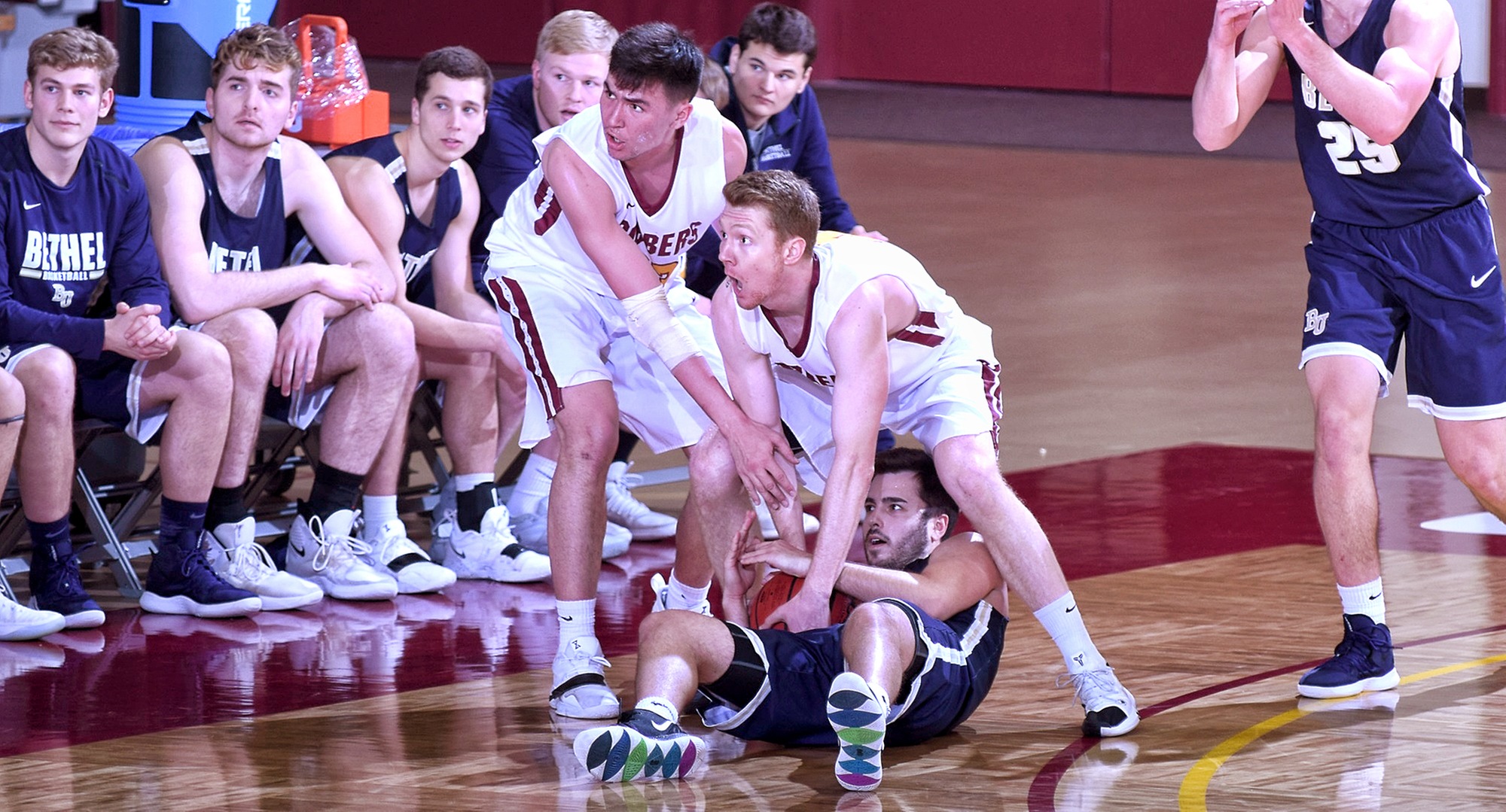 Seniors Collin Larson and Jordan Davis fight for a loose ball in the Cobbers' game with Bethel.
