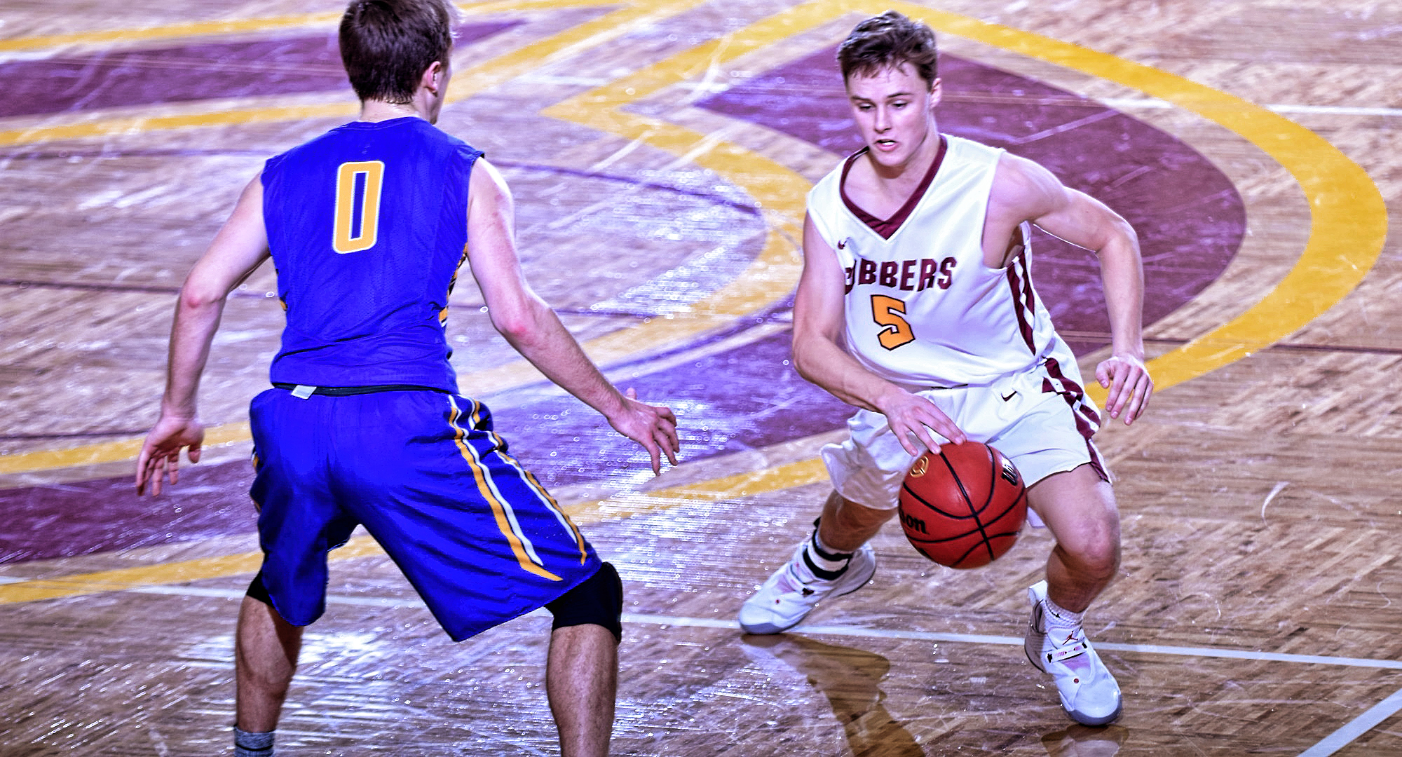 Freshman Jackson Jangula beats a defender off the dribble on his way to the basket and two of his career-high 26 points in the Cobbers' win over St. Scholastica.