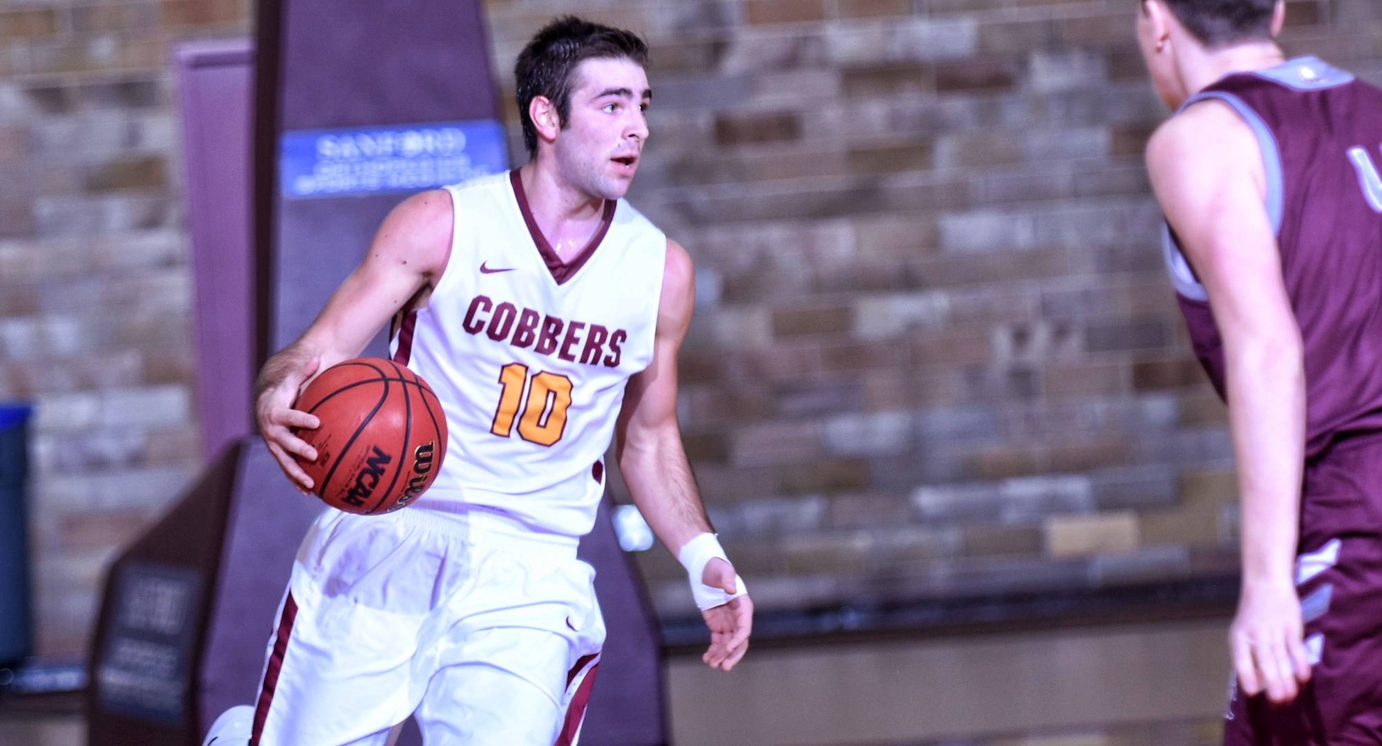 Tommy Schyma dribbles the ball upcourt during the second half of the Cobbers' game with Augsburg. He finished with a game-high 13 points.