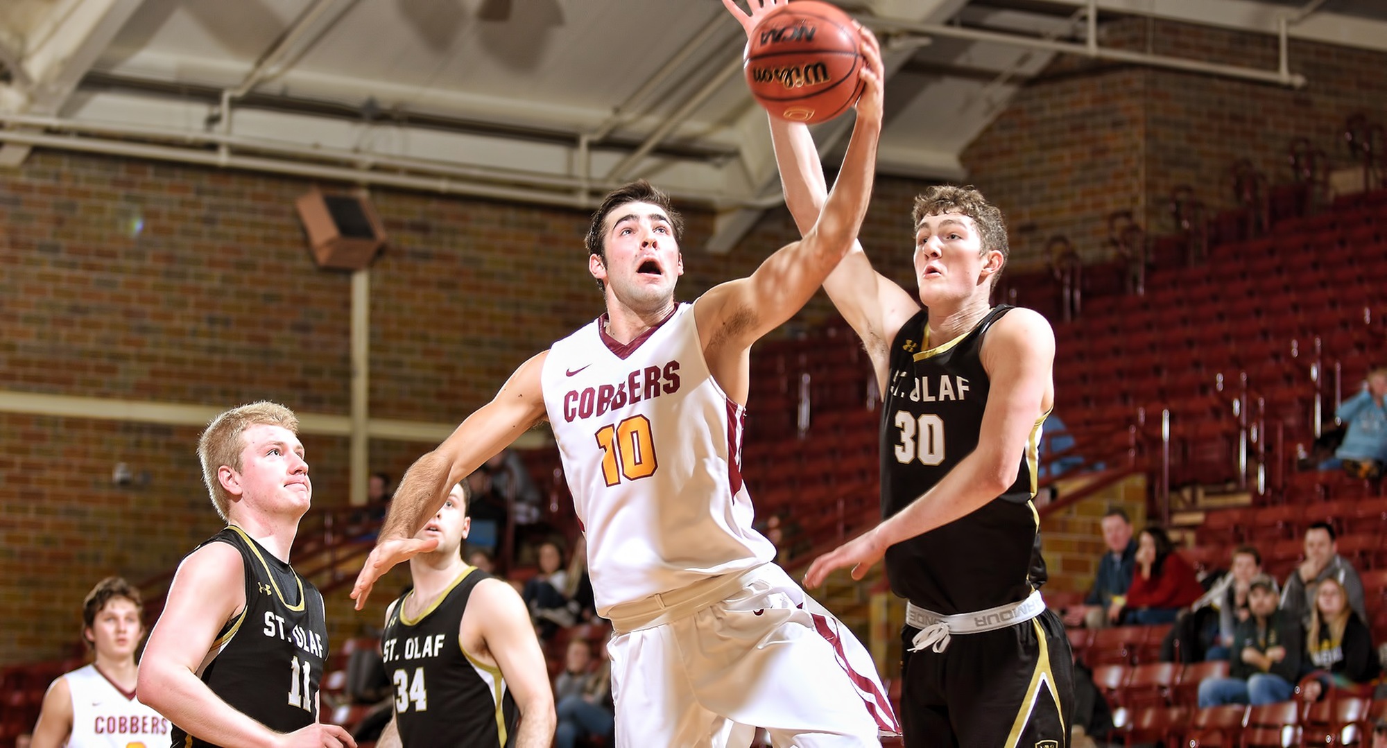 Senior Tommy Schyma goes to the basket in the second half for two of his game-high 18 points against St. Olaf.