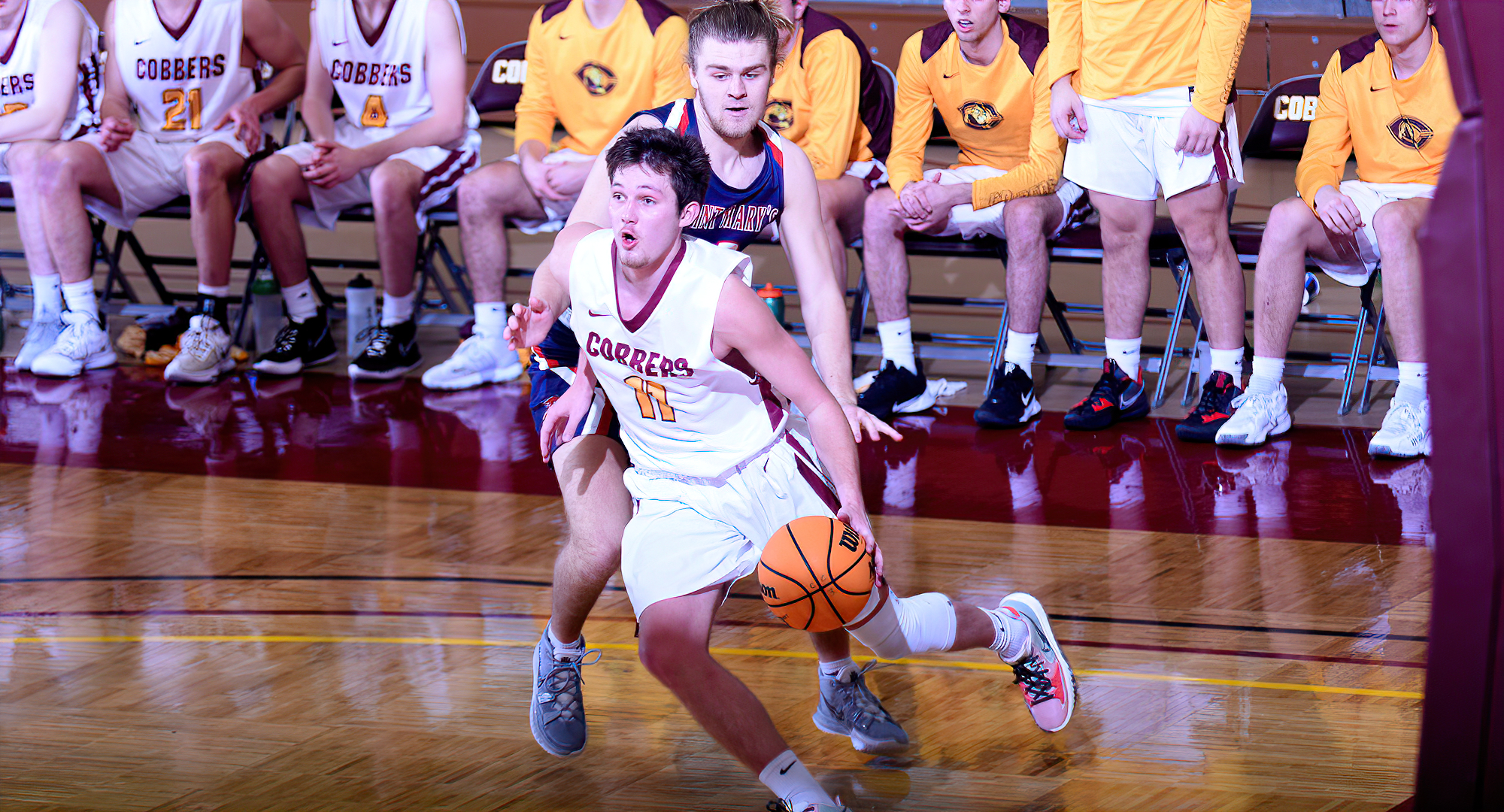 Braeton Motschenbacher dribbles by his defender on the baseline on his way to two of his game-high 22 points in the Cobbers' win over St. Mary's.