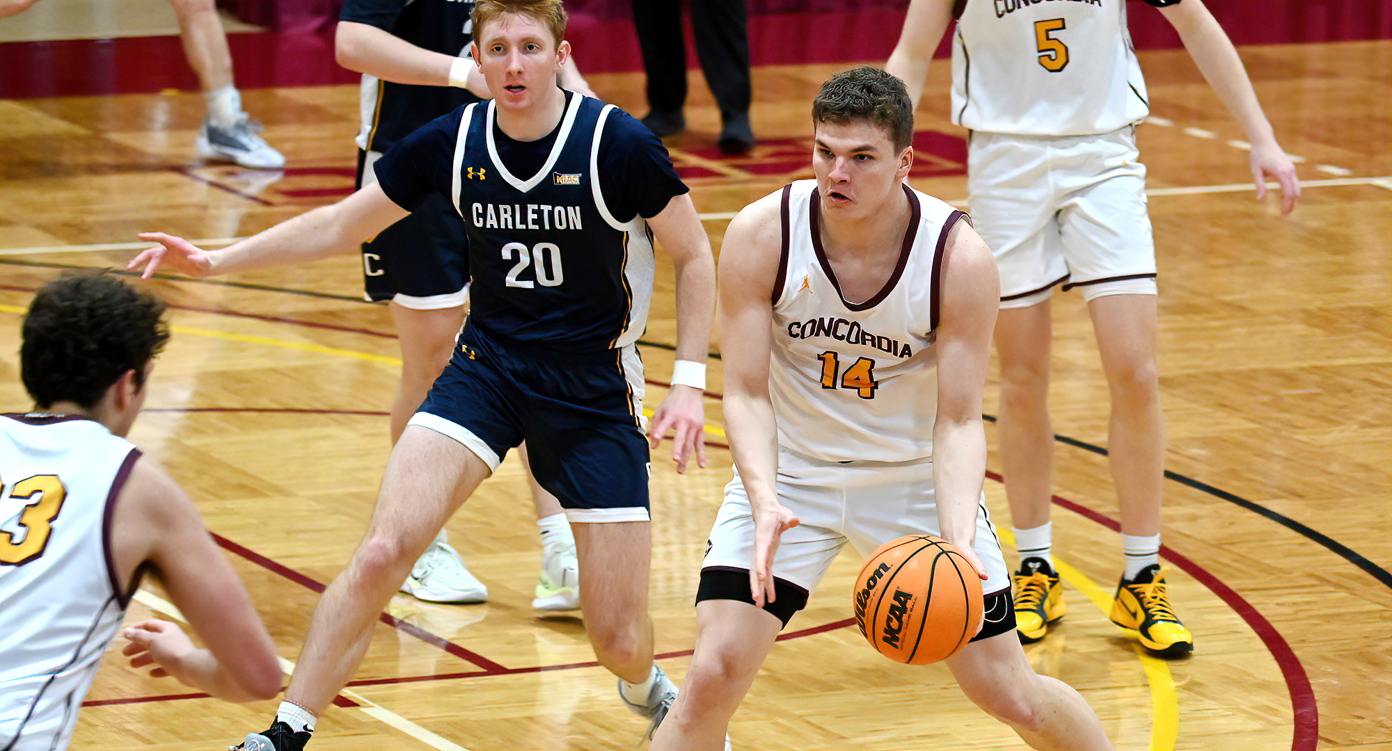 Rowan Nelson gets ready to hand the ball to Jacob Cook during CC's win over Carleton. Nelson and Cook combined for 28 points and 15 rebounds.