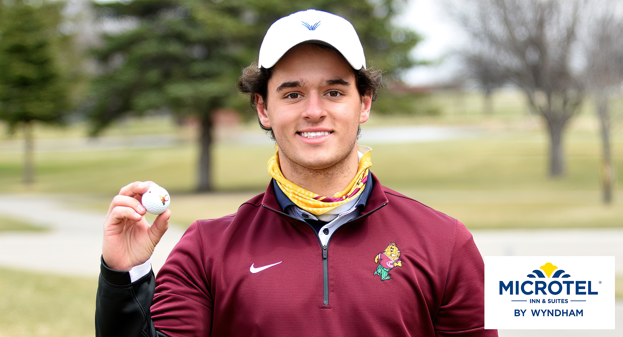 Freshman Justin Lamp holds up the ball he made a hole-in-one with on the ninth hole at Moorhead CC during the Cobbers' dual-meet win over Fergus Falls CC.