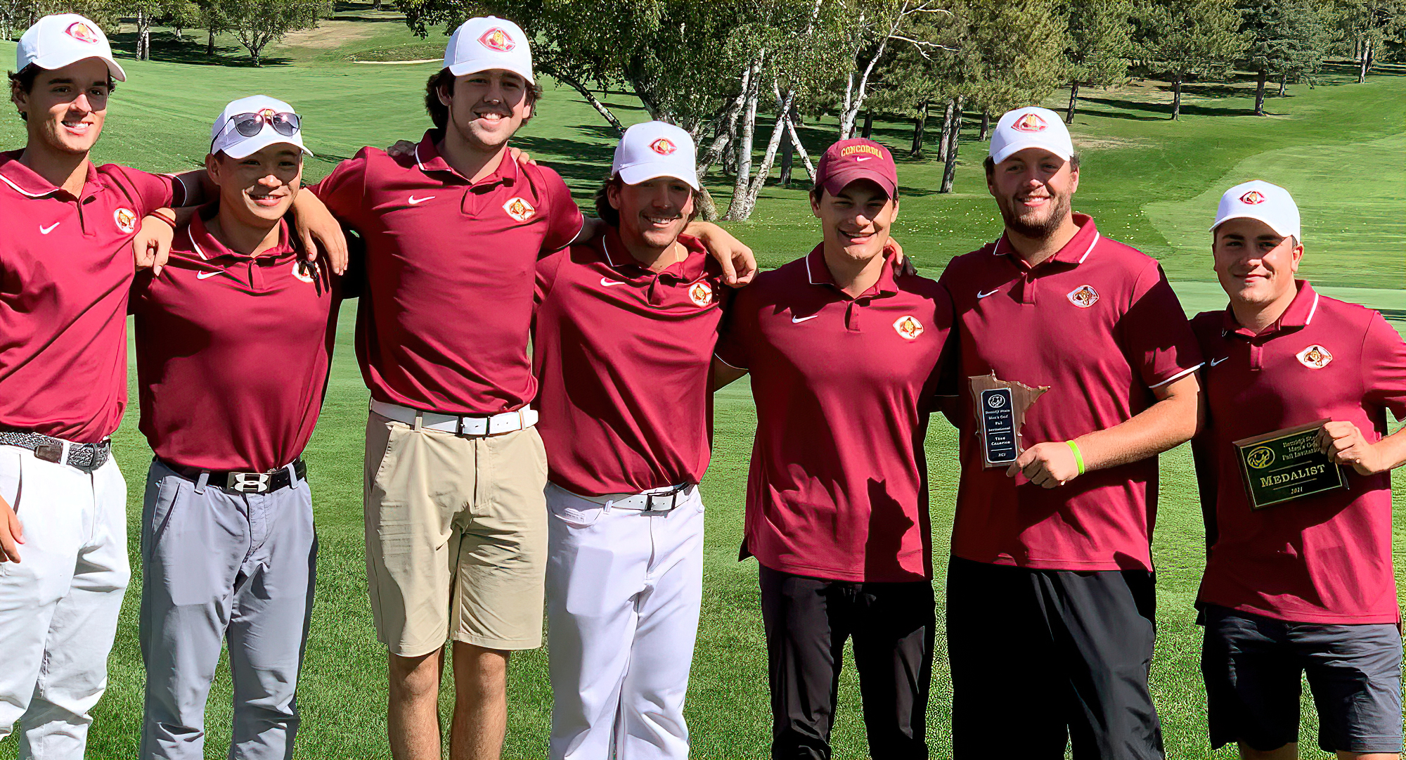 The Cobber men's squad poses with the championship trophy after winning the Bemidji State Invite. Mason Plante (R) claimed medalist honors.