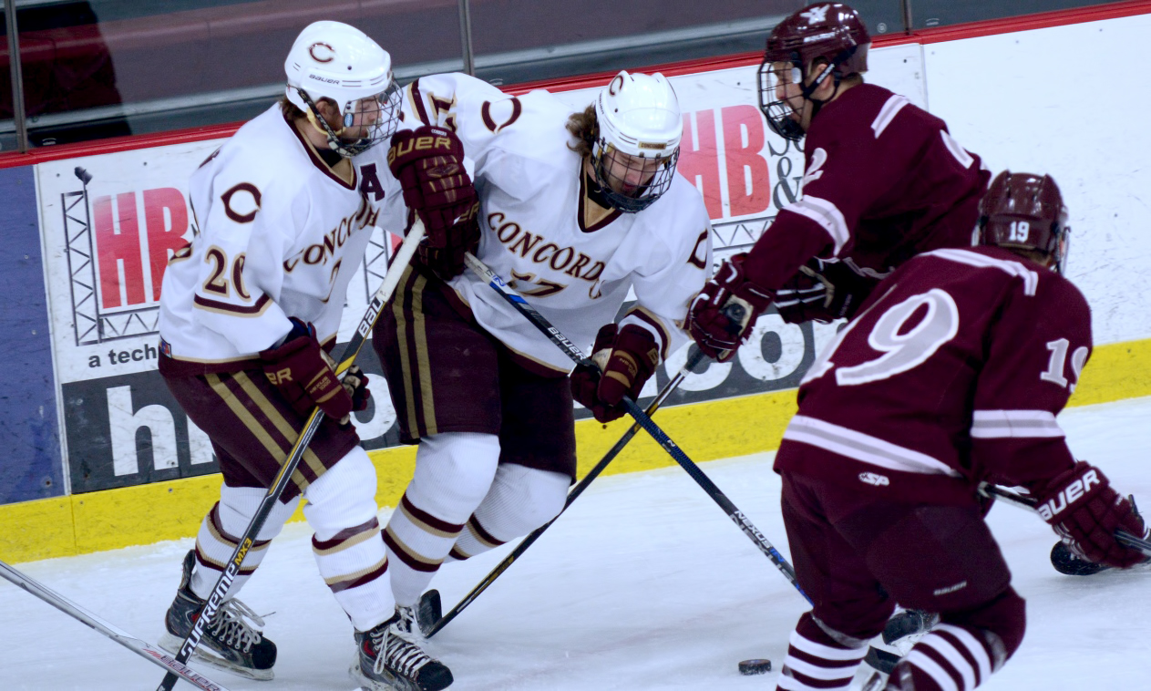 Dalton Mills (#17) and Jeremy Johnson battle for the puck in the Cobbers' series opener with Augsburg. Johnson had the assist on CC's first goal of the game.