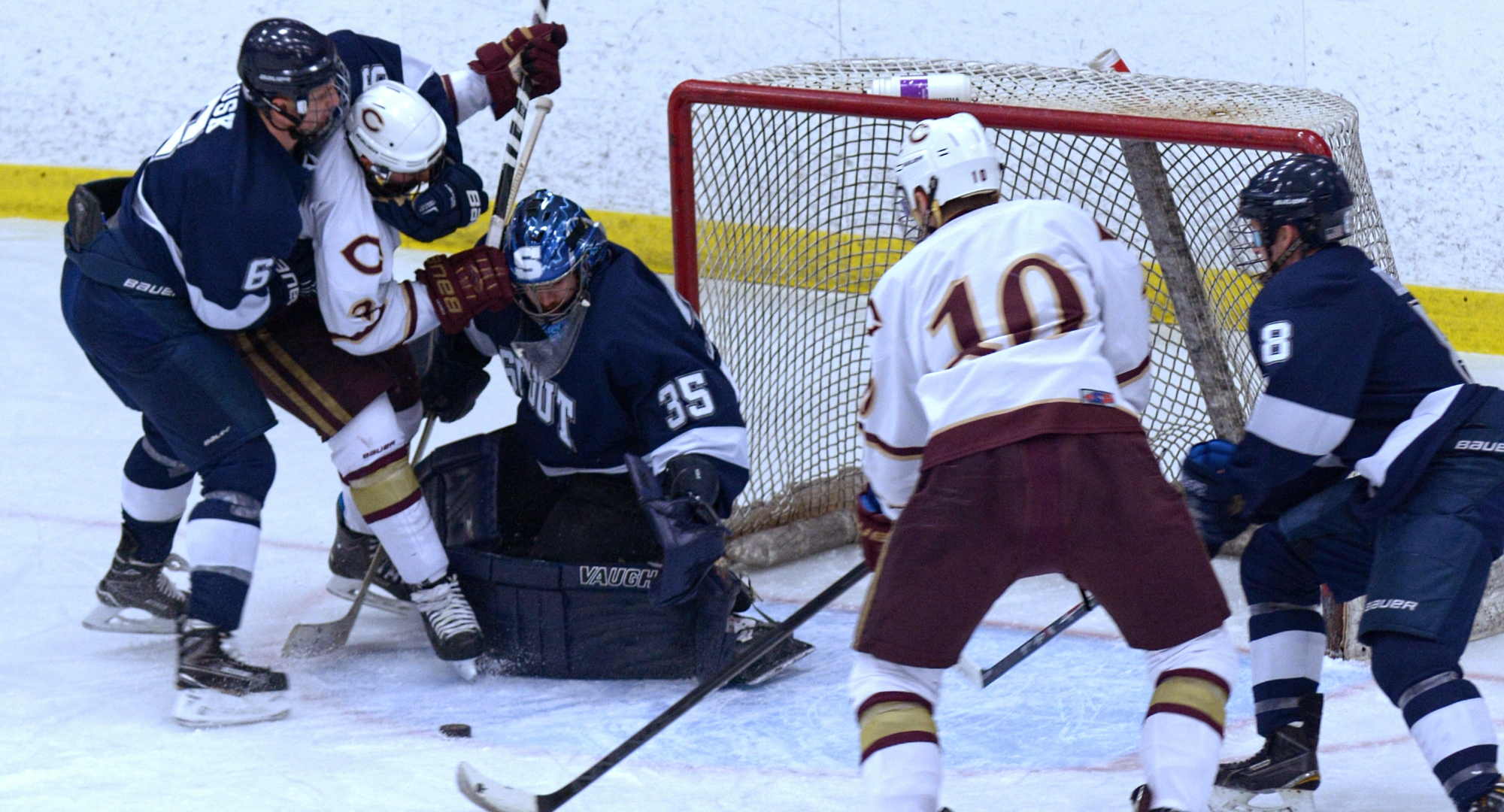 Junior Jon Grebosky gets put in a head lock as he drives towards the net during the Cobbers' 6-1 win over Wis.-Stout. Grebosky had two goals in the game.