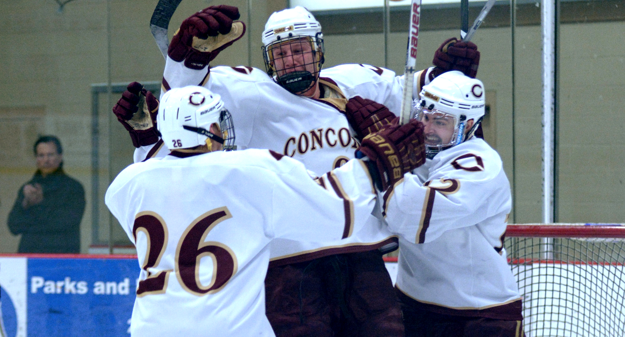 Jon Grebosky celebrates his third-period goal against Hamline with teammates Connor Kelly (R) and Quinn Fuchs (#26) during the Cobbers' shootout win over the Pipers.