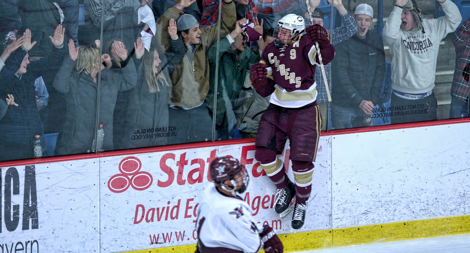 Senior Jon Grebosky jumps into the air to celebrate with the Cobber student section after his second-period goal in the series opener with Augsburg.