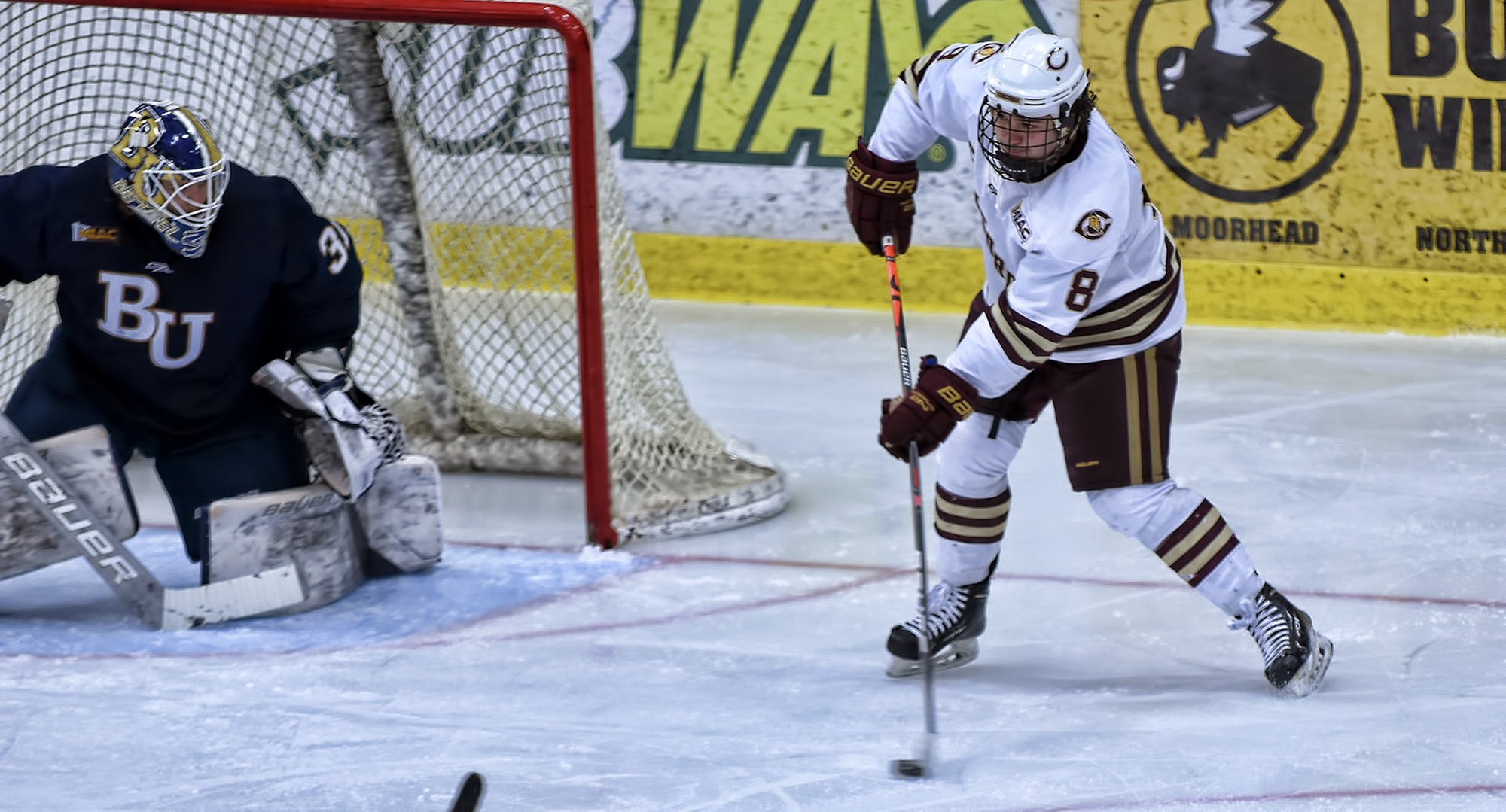 Senior Aaron Herdt makes a centering pass during the first period of the Cobbers' game with Bethel. Herdt scored both game-winning goals in the sweep over the Royals.