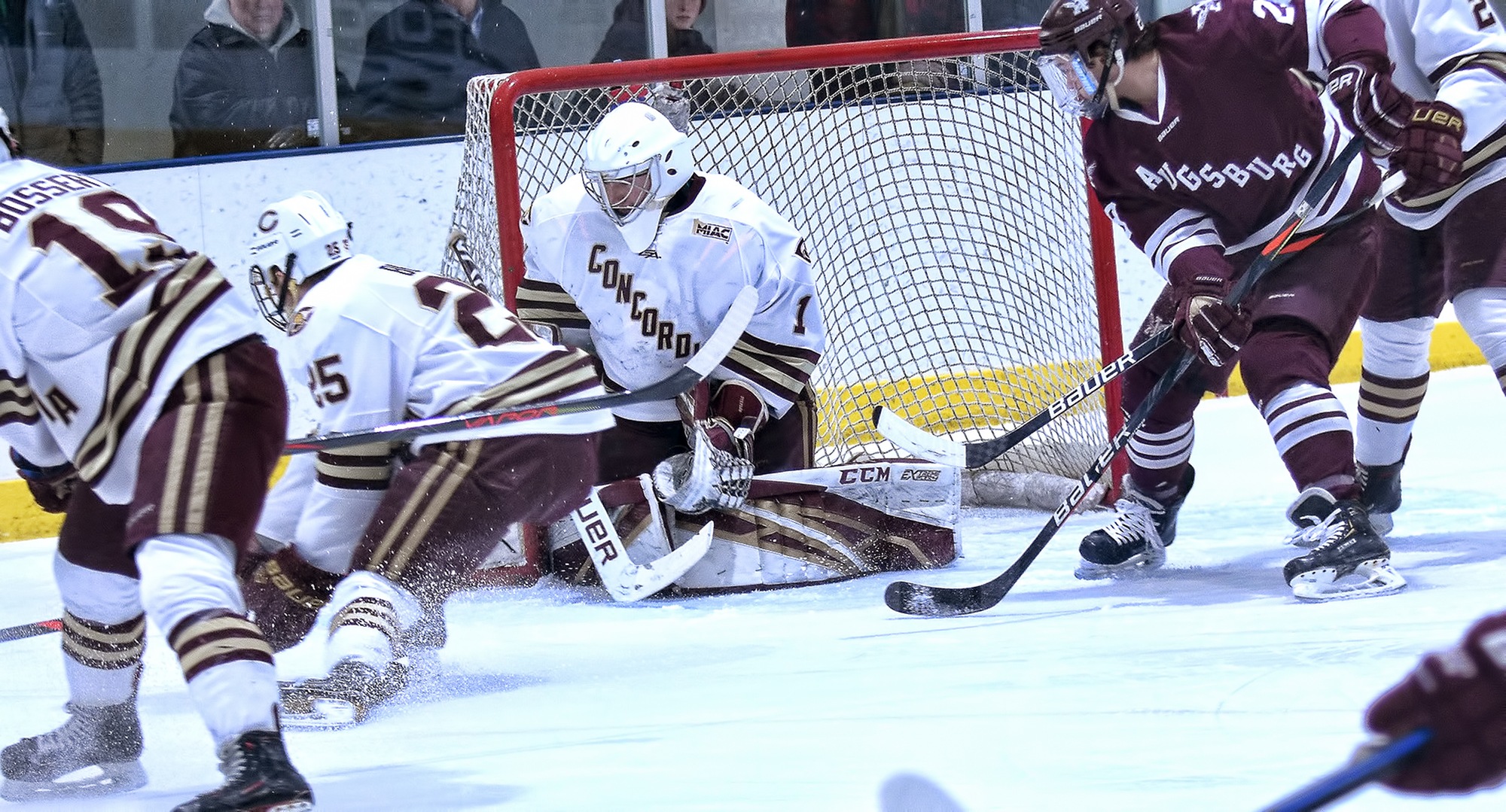 Senior Jacob Stephan goes to the ice to make the save in the first period of the Cobbers' 2-1 win against #15 Augsburg in the series finale. Stephan finished with 35 saves.