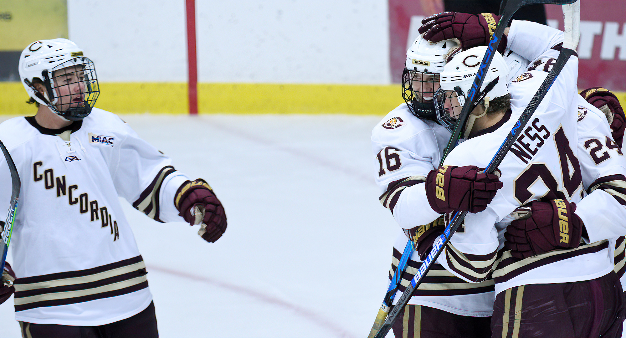 Kevin Ness (#16) congratulates his brother Nicholas after Nicholas Ness scored the first of the eight Cobber goals in an 8-3 win over St. Mary's.