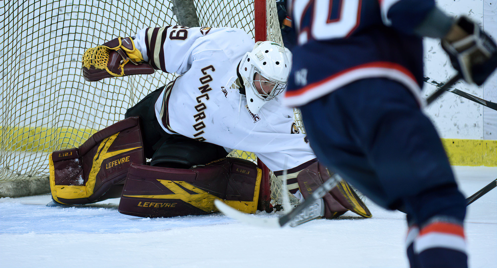 Sophomore goalie Aaron Dickstein goes down to block a wraparound attempt during the Cobbers' 3-0 win over Northland.