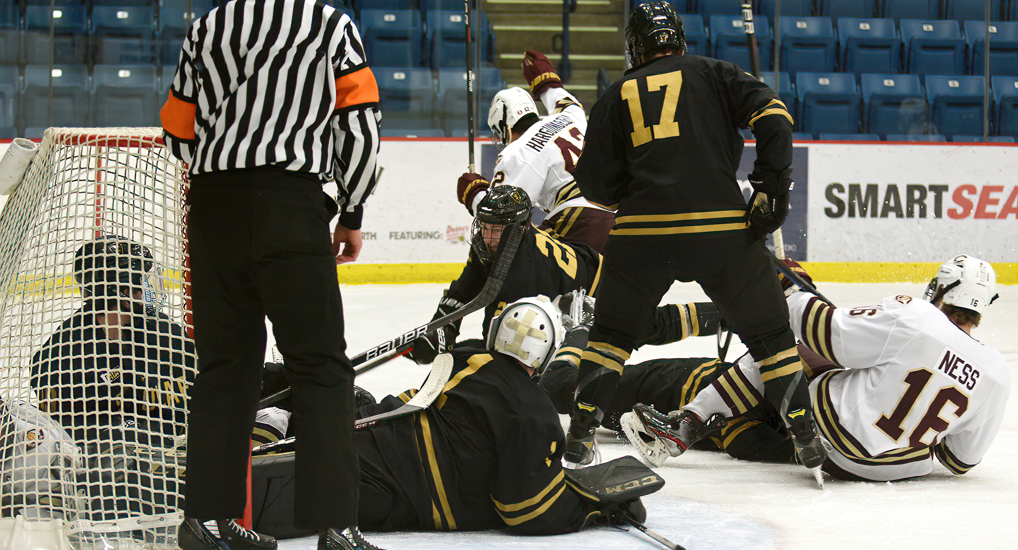 Joe Harguindeguy (#42) celebrates his 1st-period goal after he poked home a rebound with multiple players crashing into the St. Olaf goal.