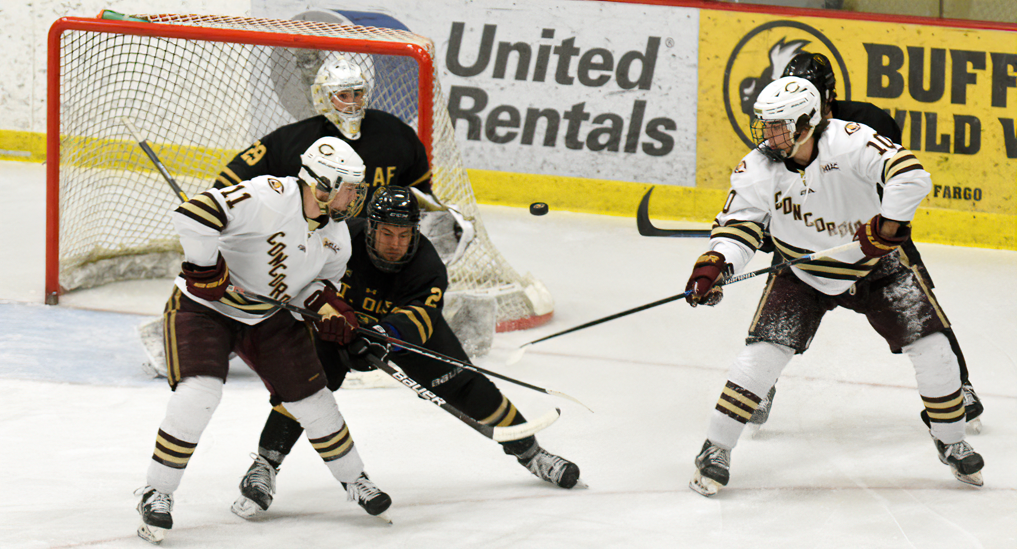 Jacen Bracko (L) and Hunter Olson (R) watch as a shot goes between them and on the net during the Cobbers' MIAC quarterfinal game with St. Olaf.