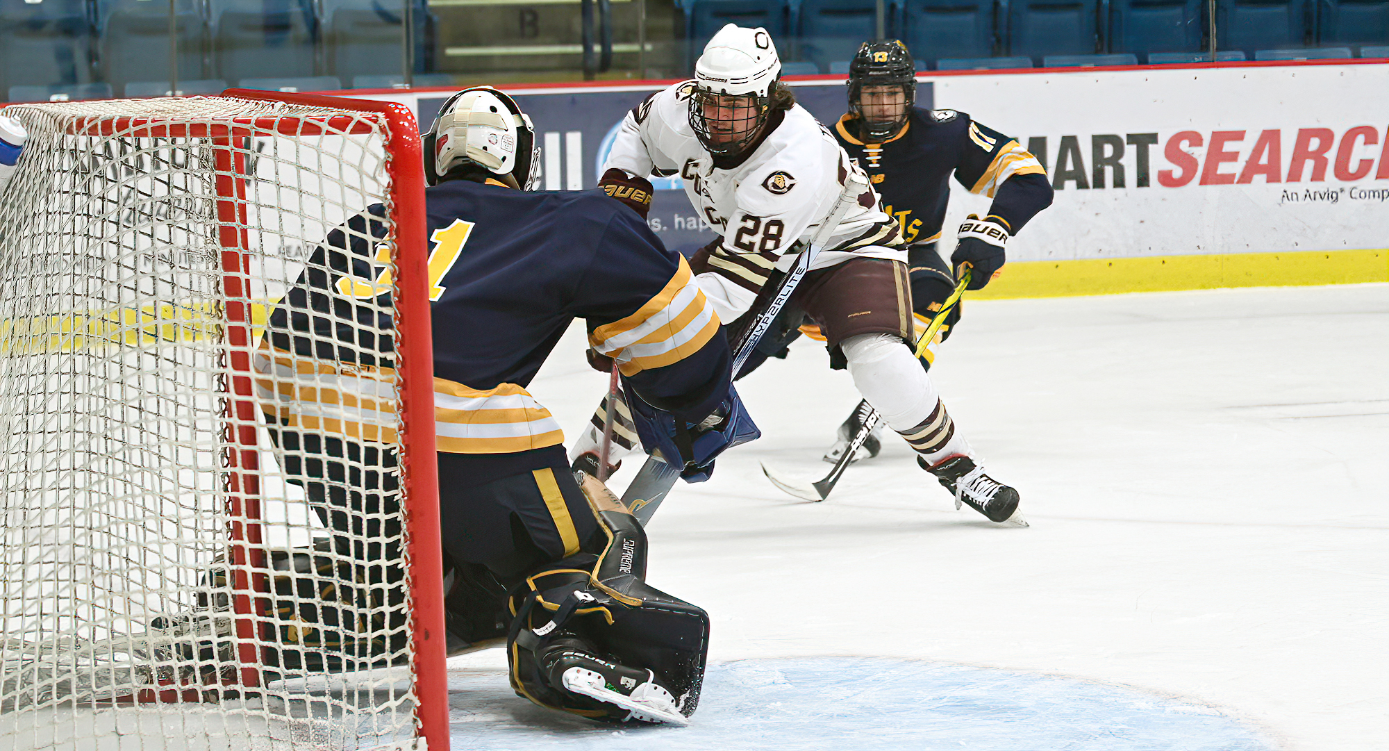 Caden Triggs drives toward the net in the Cobbers' series finale with #2 St. Scholastica. Triggs had a goal and an assist in the game.
