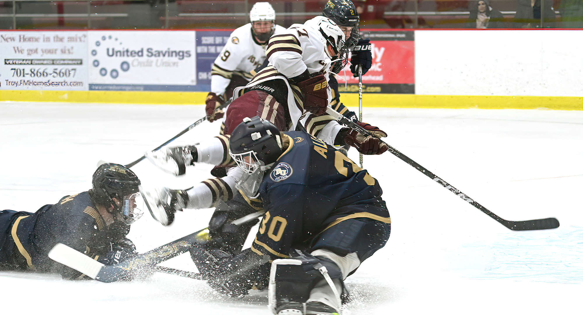 Forward Mason Plante goes flying over the Bethel goalie in the Cobbers' series opener with the Royals.