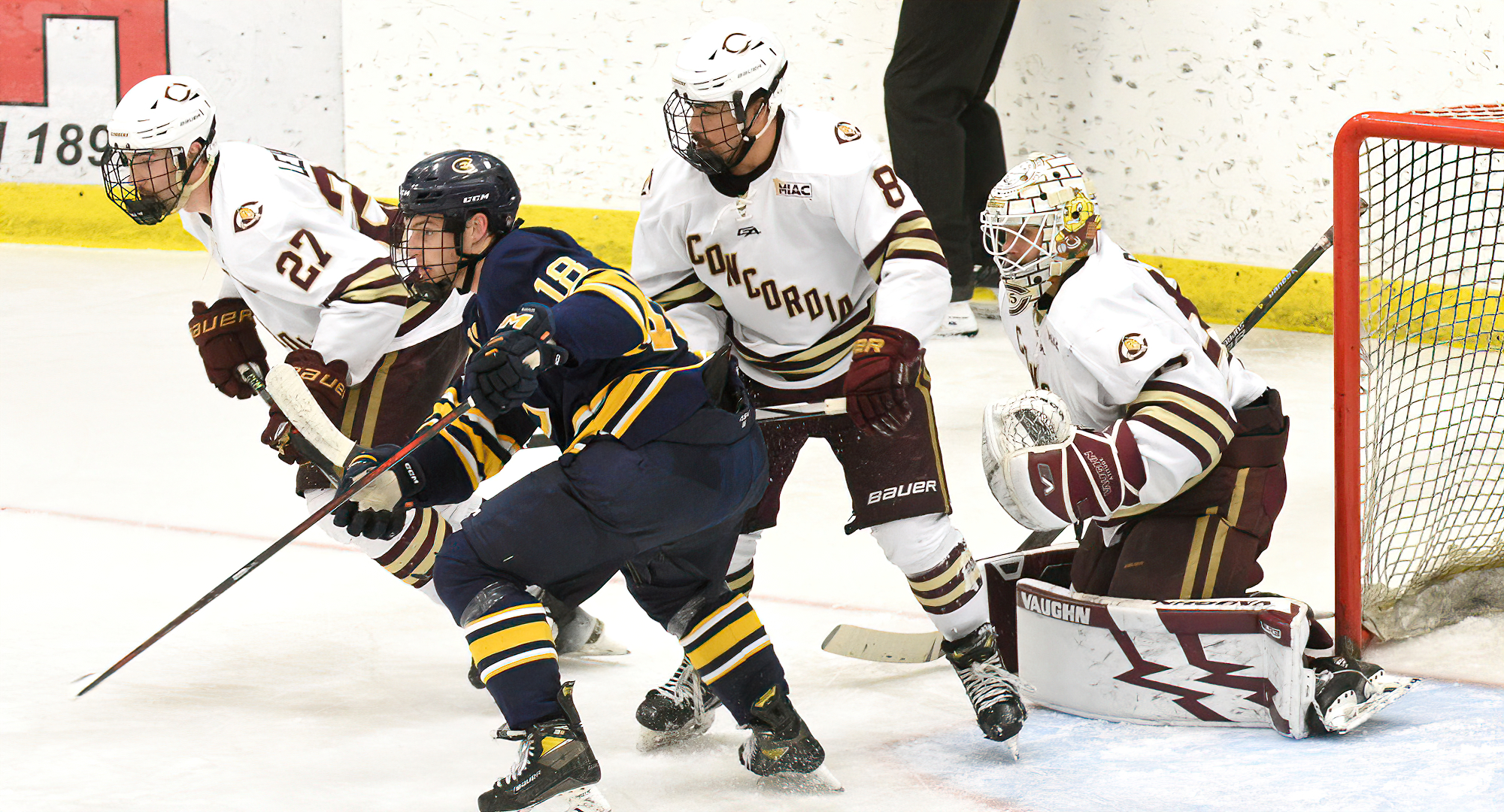 Cole Lehman (#27) and Joe Harguindeguy clear traffic in front of Cobber goalie Dane Couture in the Cobbers' 3-1 win over UW-Eau Claire.