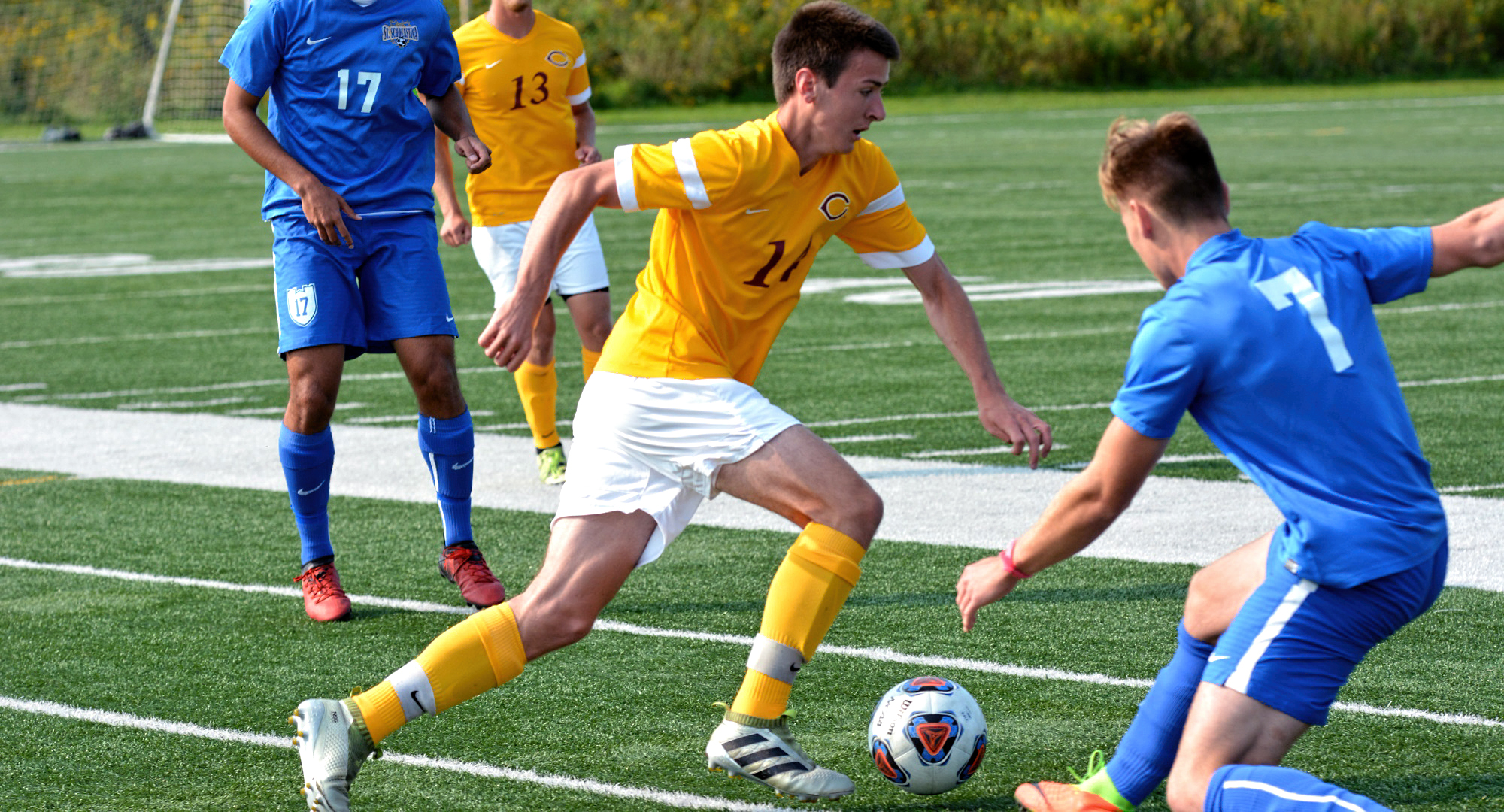 Sophomore Noah Gjesdahl eludes a St. Scholastica during the Cobbers' opening weekend of play. (Photo courtesy of St. Scholastica Sports Info Department)