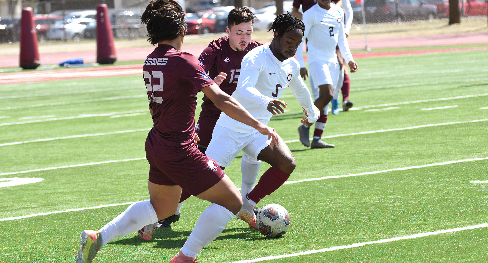 Telvin Vah dribbles between a pair of Augsburg defenders in the Cobbers' 4-3 OT win. Vah had the assist on the late game-tying goal and then scored the game winner in OT.