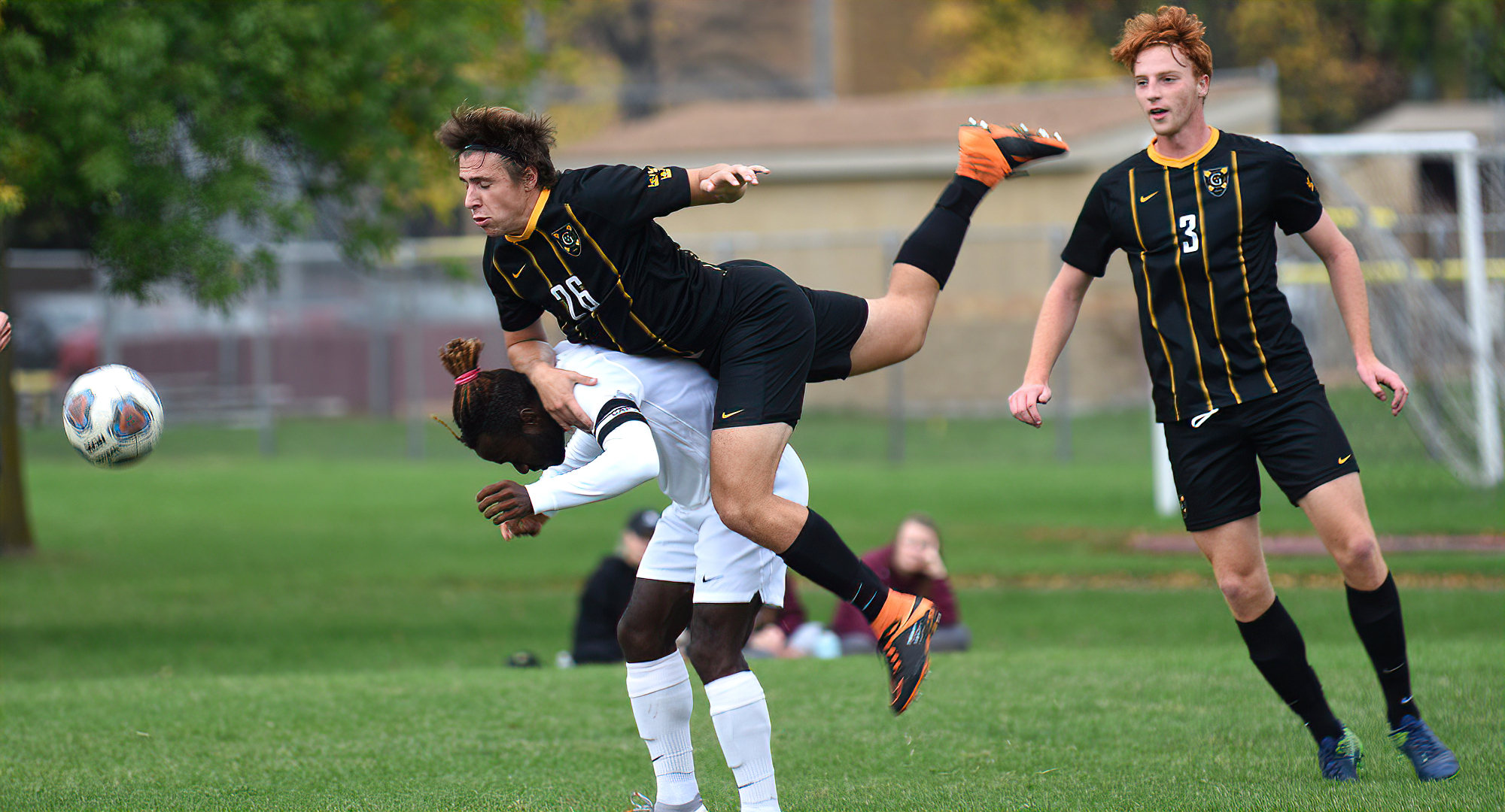 A Gustie player goes over the back of Cobber junior Telvin Vah during the original game between the team. Vah scored in the make-up game at CSB.