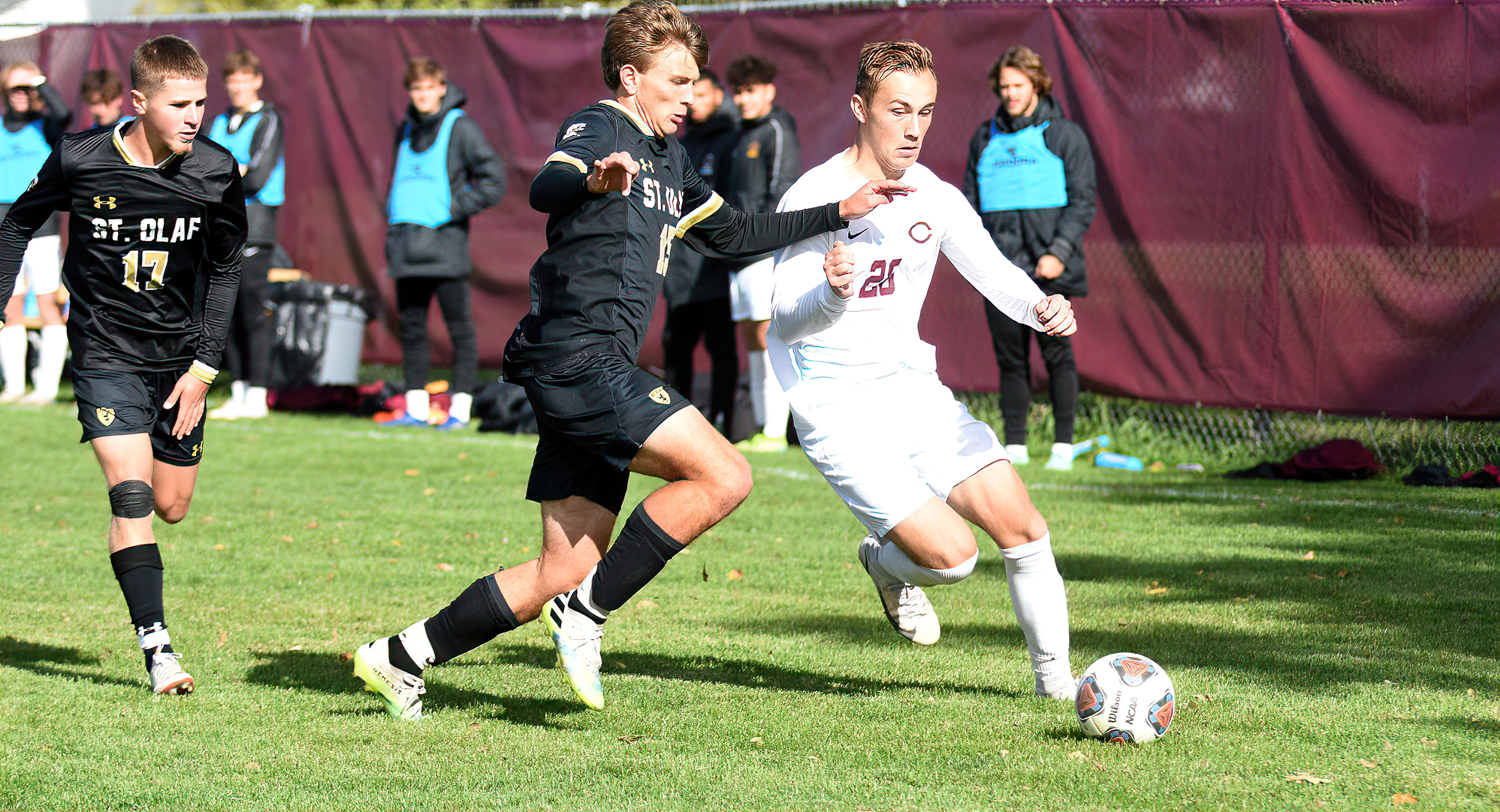 Freshman Cameron Bolinske holds off a St. Olaf defender during the second half of the Cobbers game with the No.10-ranked Oles.