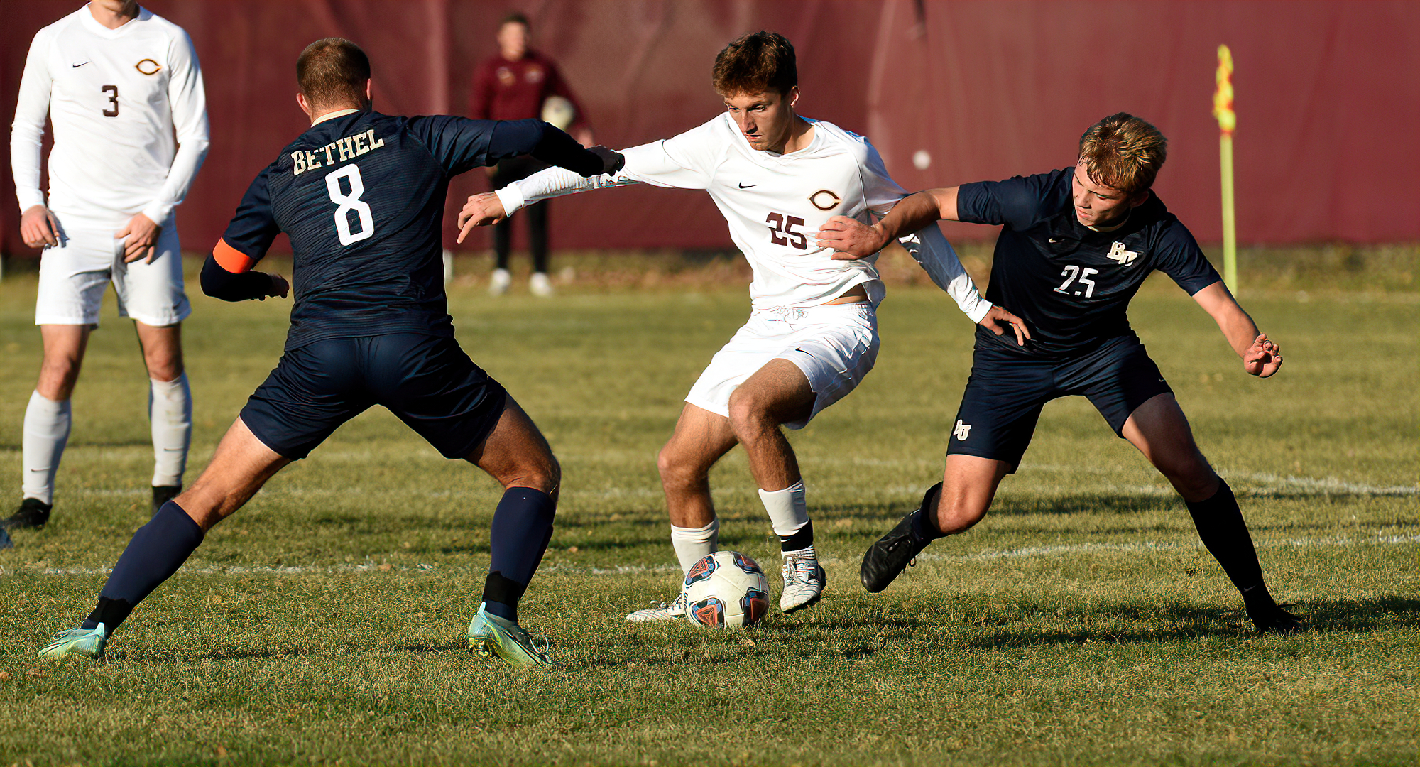 Freshman Gannon Brooks tries to split a pair of Bethel defenders during the Cobbers' final home game against the Royals.