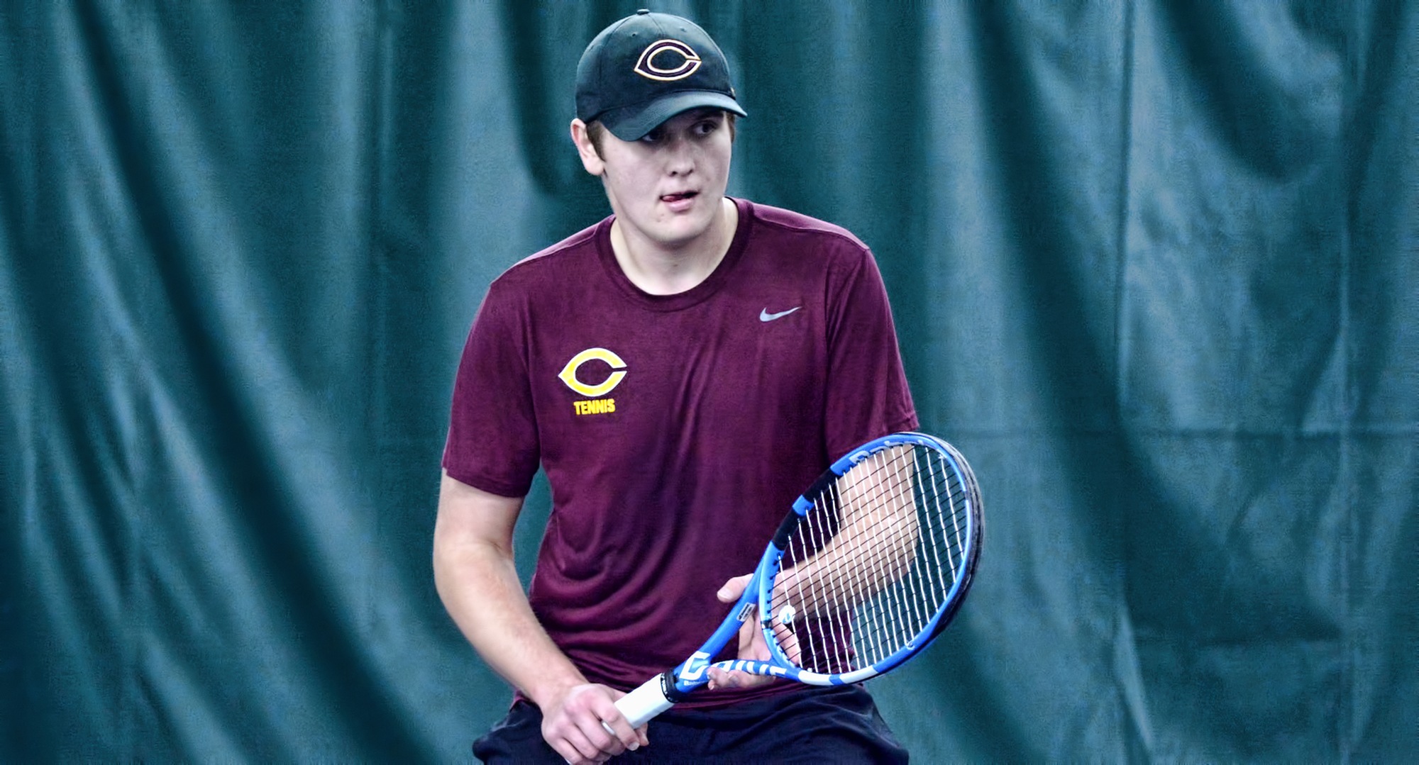 Freshman Ben Swanson gets ready to make a return during his singles win against Macalester. Swanson earned his career conference win vs. the Scots.