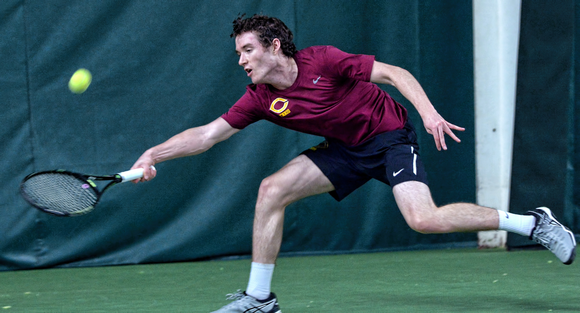 Sophomore Erik Porter stretches for a forehand. He cruised to a 6-1, 6-1 win at No.2 singles in the Cobbers' 5-4 win over St. Olaf.