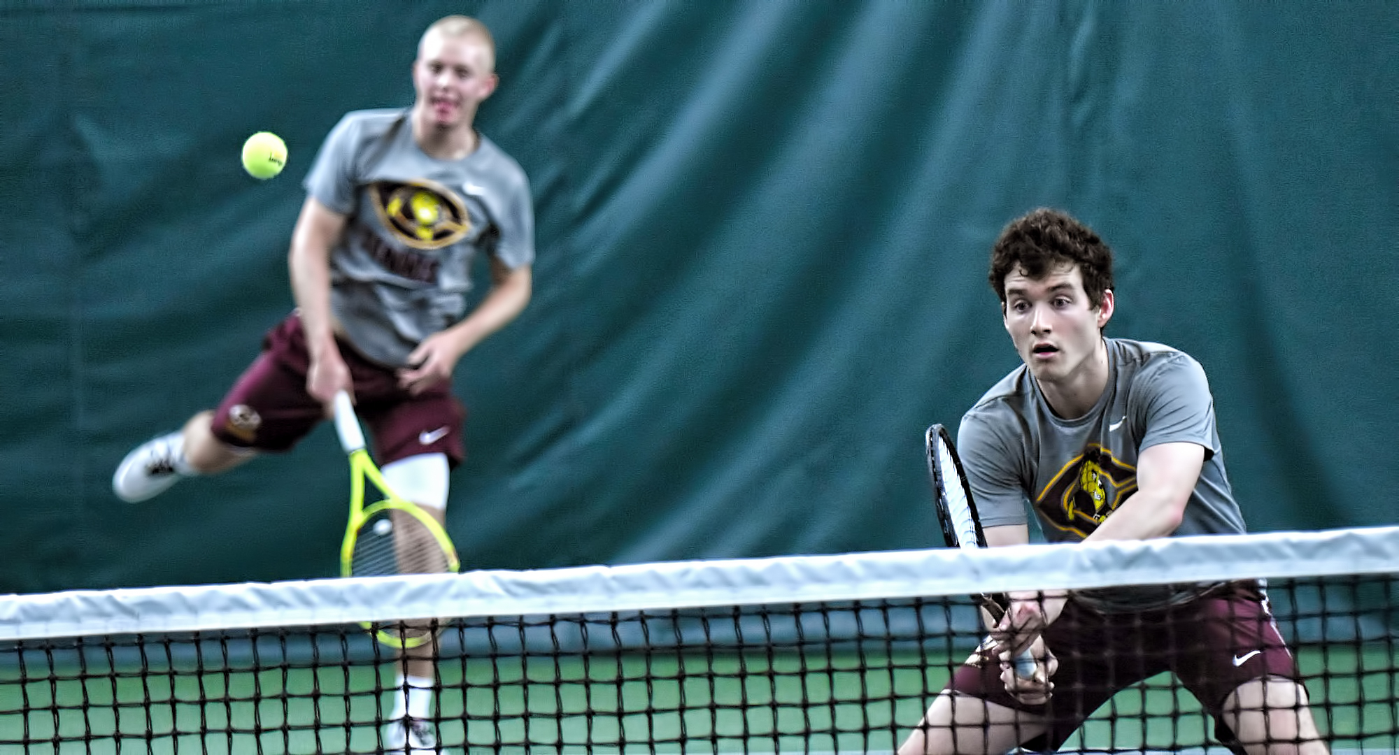 Jared Saue makes the serve and doubles partner Erik Porter waits for the return in their match at No.1 doubles. The tandem won 8-6 in their match with St. John's.