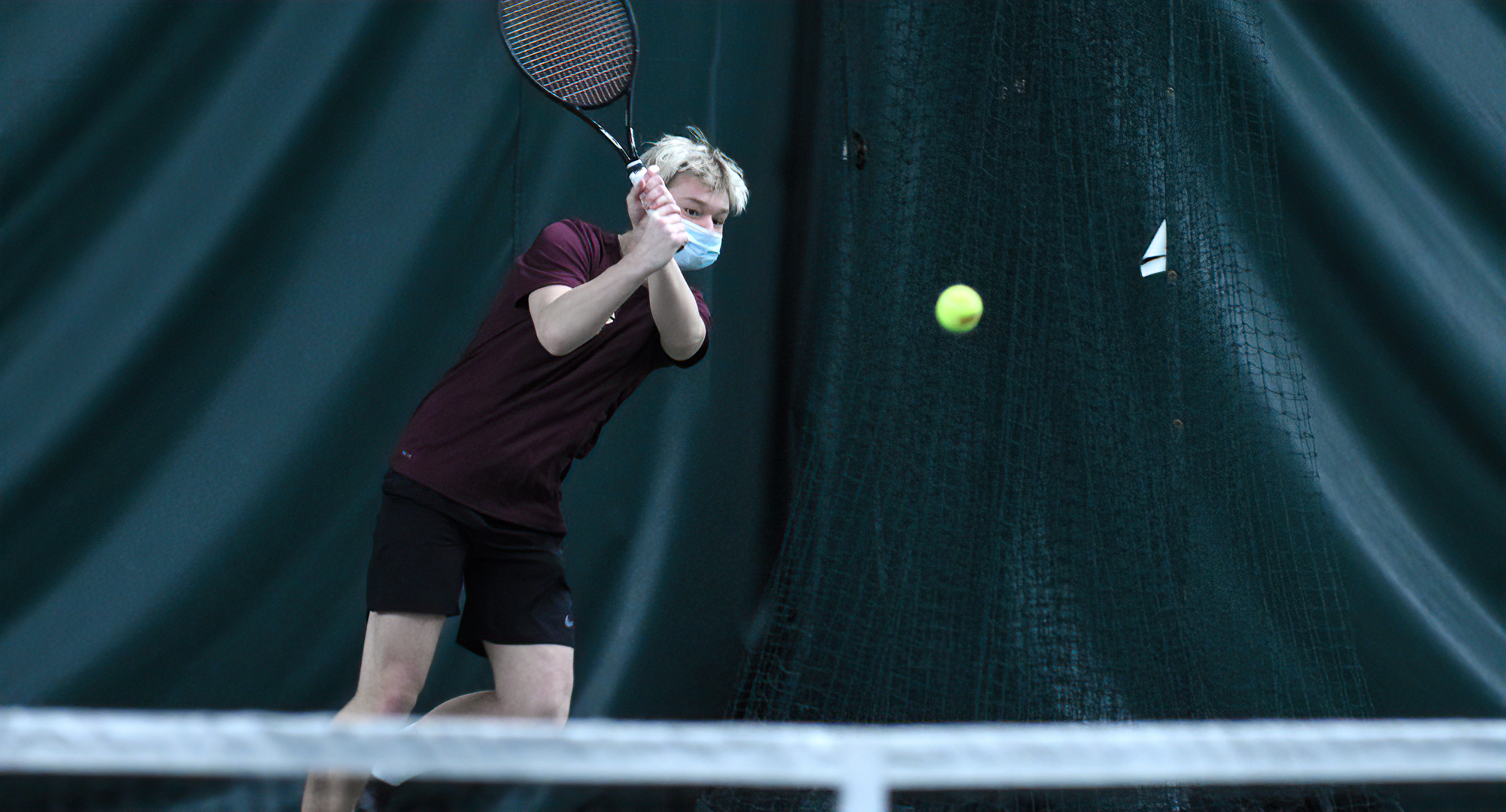 Sophomore Cole Gillespie follows through on a backhand during his No.2 singles match on Sunday against Gustavus.