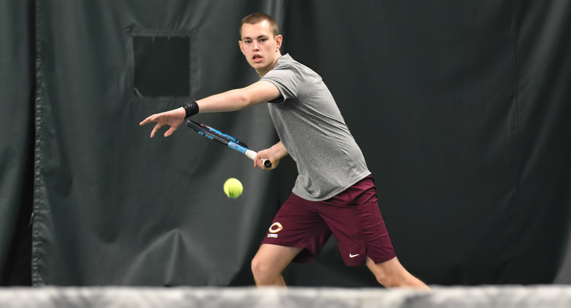 Freshmen Atticus Baker gets ready to return a serve during his No.4 singles match. Baker won 6-1, 6-0 to post his first college singles win.