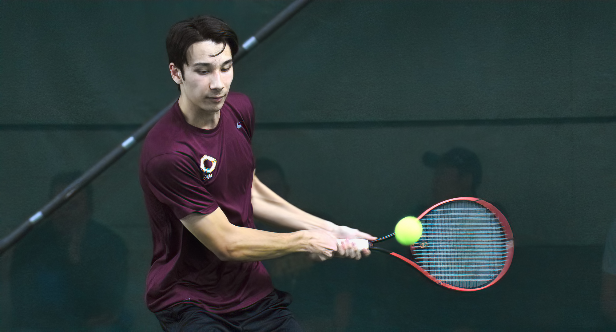 Freshman Kai Pierce goes for the backhand return during the Cobbers' two matches against UMAC opponents. Pierce is 5-1 in singles this season.