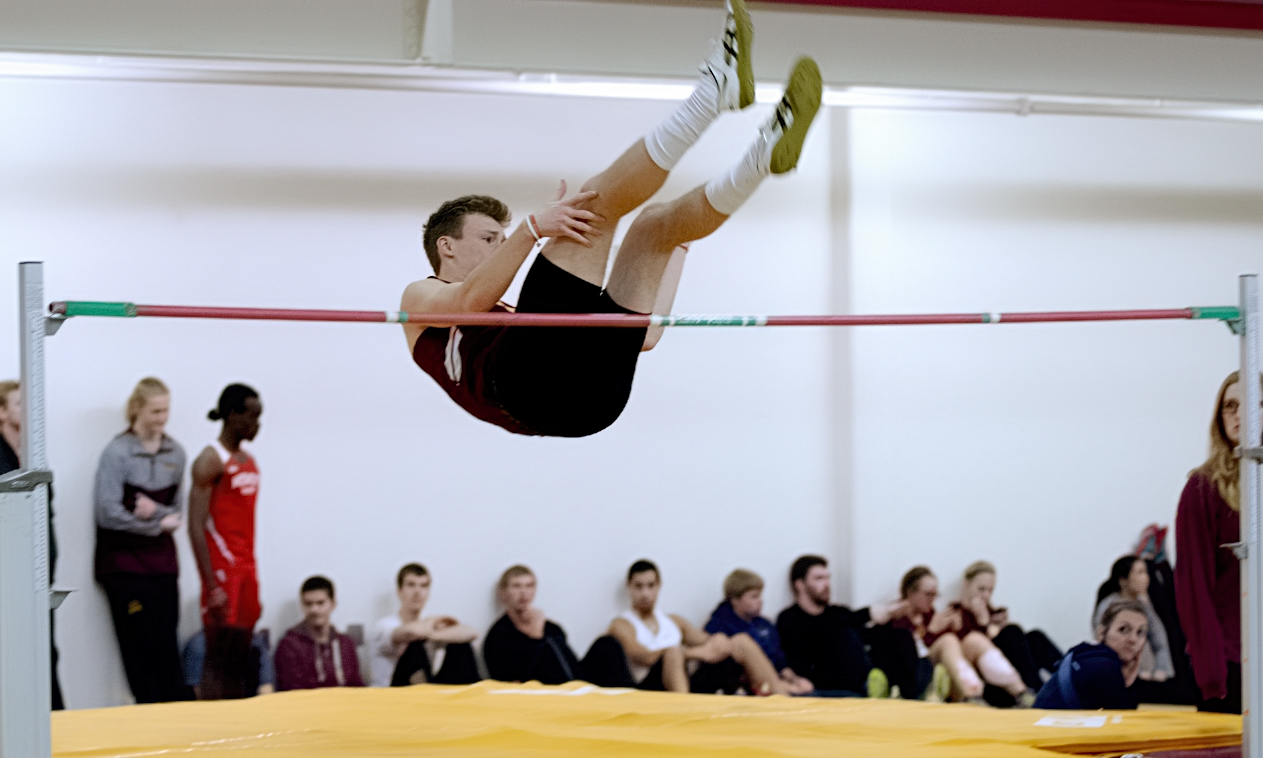 Junior Jackson Schepp clears the bar in the high jump at the season-opening Cobber Duals Meet. He finished third in the event with a height of 6-03.25.