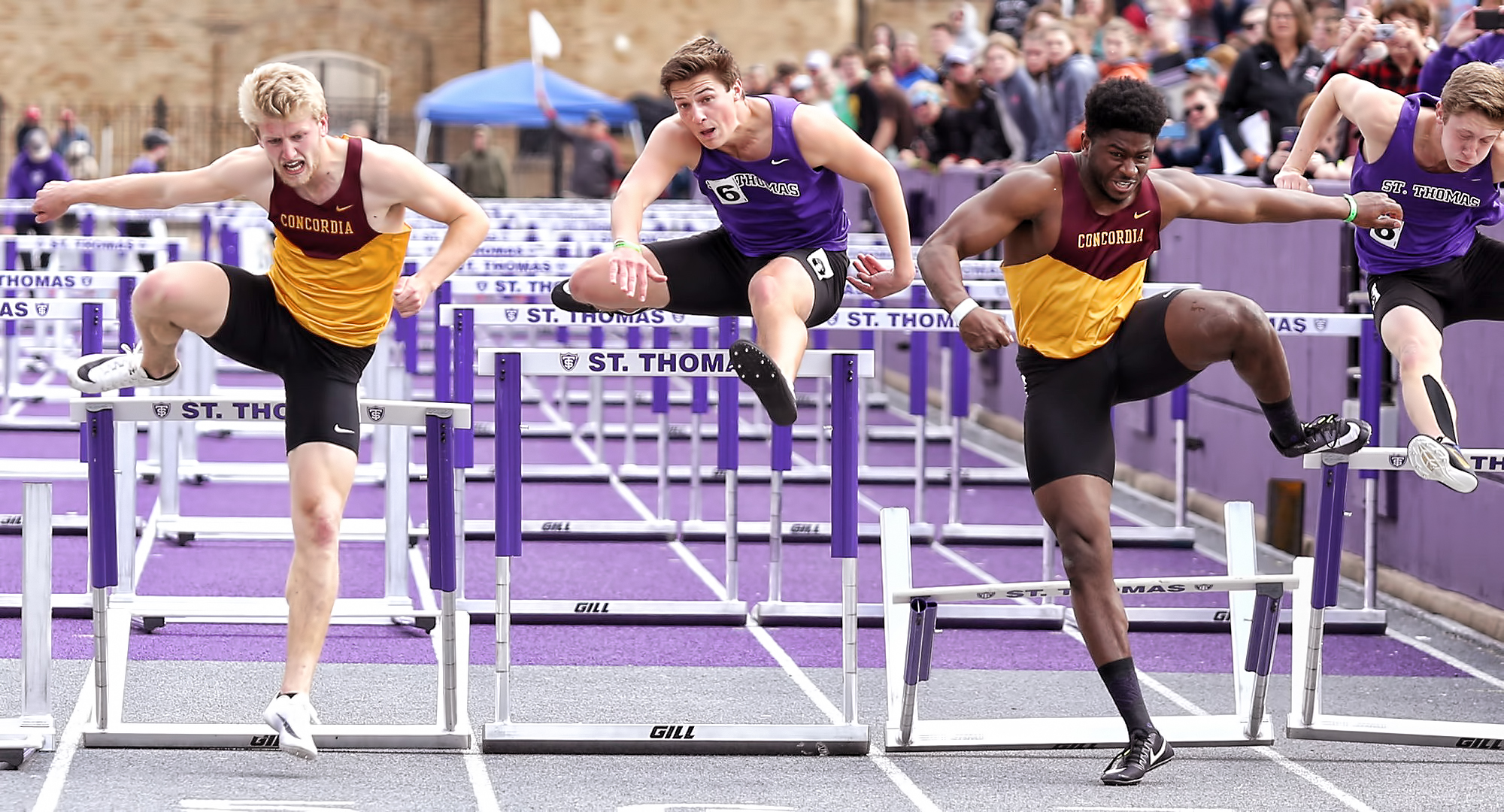 Willie Julkes (R) and Matt Bye both clear the last hurdle on their way to Top 5 finishes in the 110-meter hurdles at the MIAC Meet. (Photo courtesy of Nathan Lodermeier).
